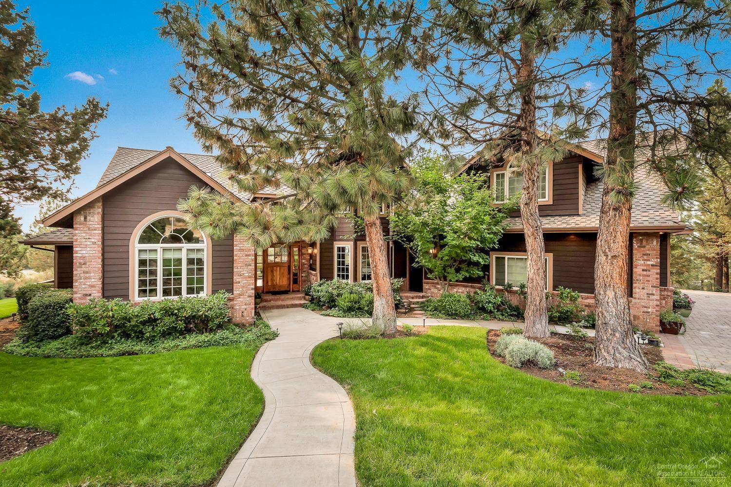 This timeless Awbrey Butte home has beautiful views of the Cascade mountains and sits nestled on a large private lot. Boasting over 4000 square feet, this home has a room for all with five bedrooms including a main level master with fireplace and steam shower, junior suite, 4.5 baths, office and bonus room. Vaulted great room opens to expansive deck ideal for entertaining. Custom features throughout, including Cherry cabinetry, slab countertops and hardwood floors. Three-car garage for all of your toys.
