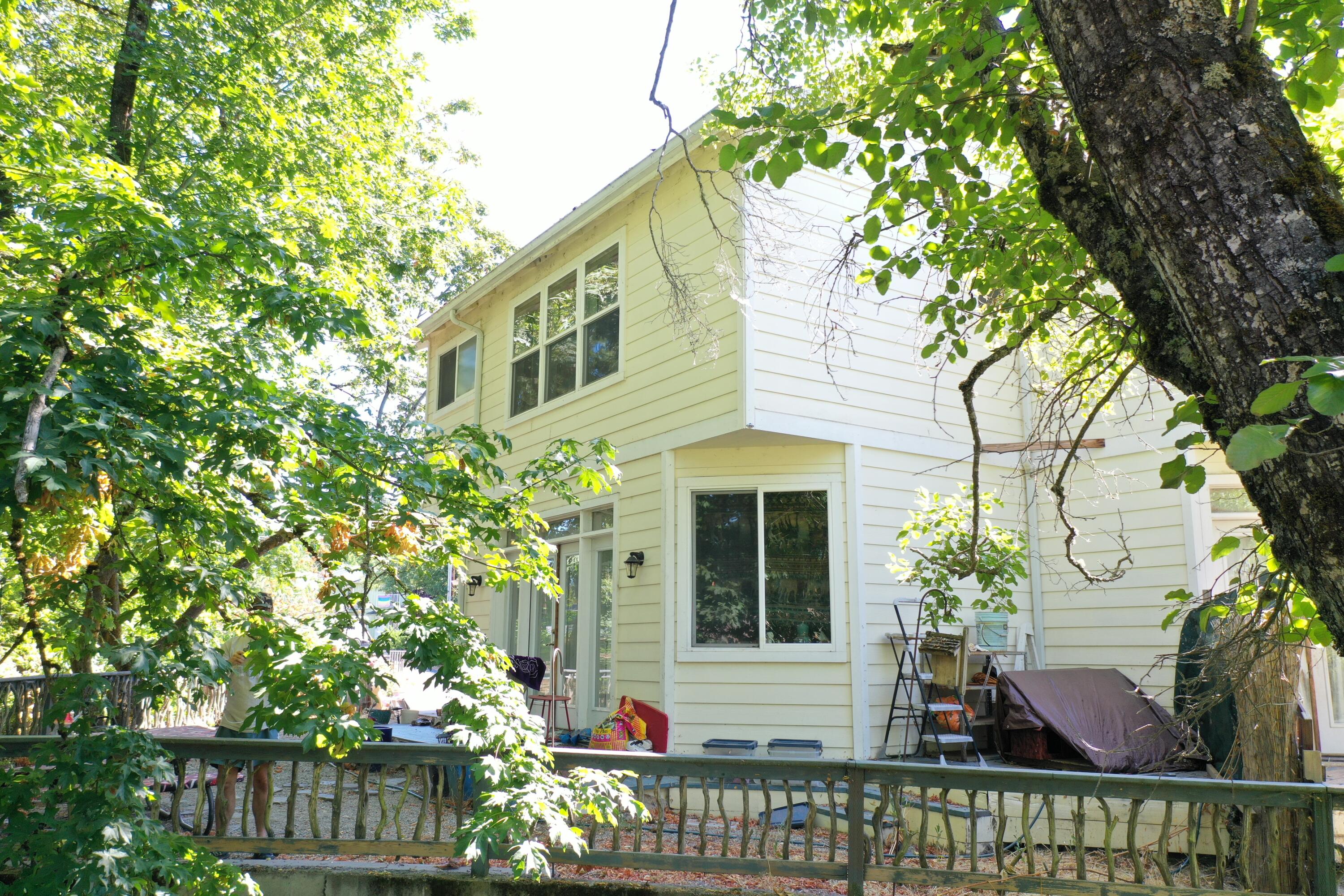 This unique 3-bedroom, 2.5-bath home blends seamlessly with the curves of Gilbert Creek in central Grants Pass. Beautiful privacy, the doors and windows fill the home with the soothing sounds of water and views of trees, creating a peaceful retreat. The open first floor features cherry wood floors and remodeled kitchen with granite counters and an island. Upstairs, the master suite offers vaulted ceilings and treetop views, while a bright guest room overlooks the creek. Enjoy the feel of country living - with the convenience of town and the excitement of the Rogue River just moments away.