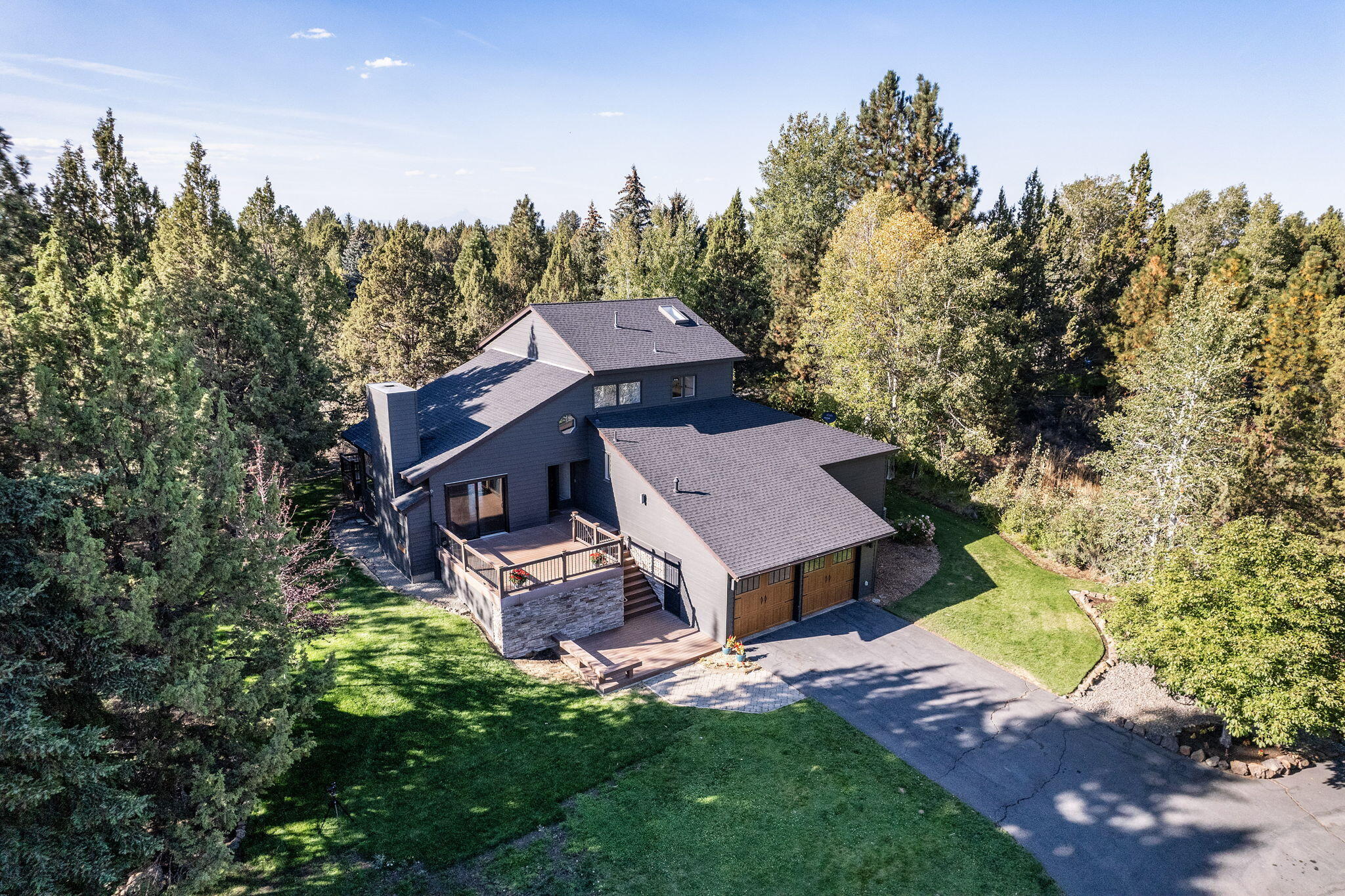 Come Home to this beautiful custom house on 2.2 acres. Enjoy expansive windows with lots of natural light. Spacious open kitchen. River Rock wood-burning fireplace with gas insert/starter. Vaulted ceilings in great room and primary suite. Primary bedroom w/ floor to ceiling window wall for glorious sunset viewing, along with heated flooring in the double vanity bath and a soaker tub, tile shower and separate water closet & a large open walk-in closet. New flooring,  newly painted interior. New hard surface counter tops.  new pluming fixtures. Two downstairs bedrooms & shared hall bath w/heated flooring & double vanity. A bonus/office/media room offers 220 sf of flex space. Furnace & AC located in storage room off the garage. Large Trex decks with privacy for entertaining. Mature professional landscaping. The three garage door 1280sf detached shop/garage has plumbing and electrical. Along with full length enclosed loft which could be finished into ADU. C.O.I.D. .25 irrigation water.