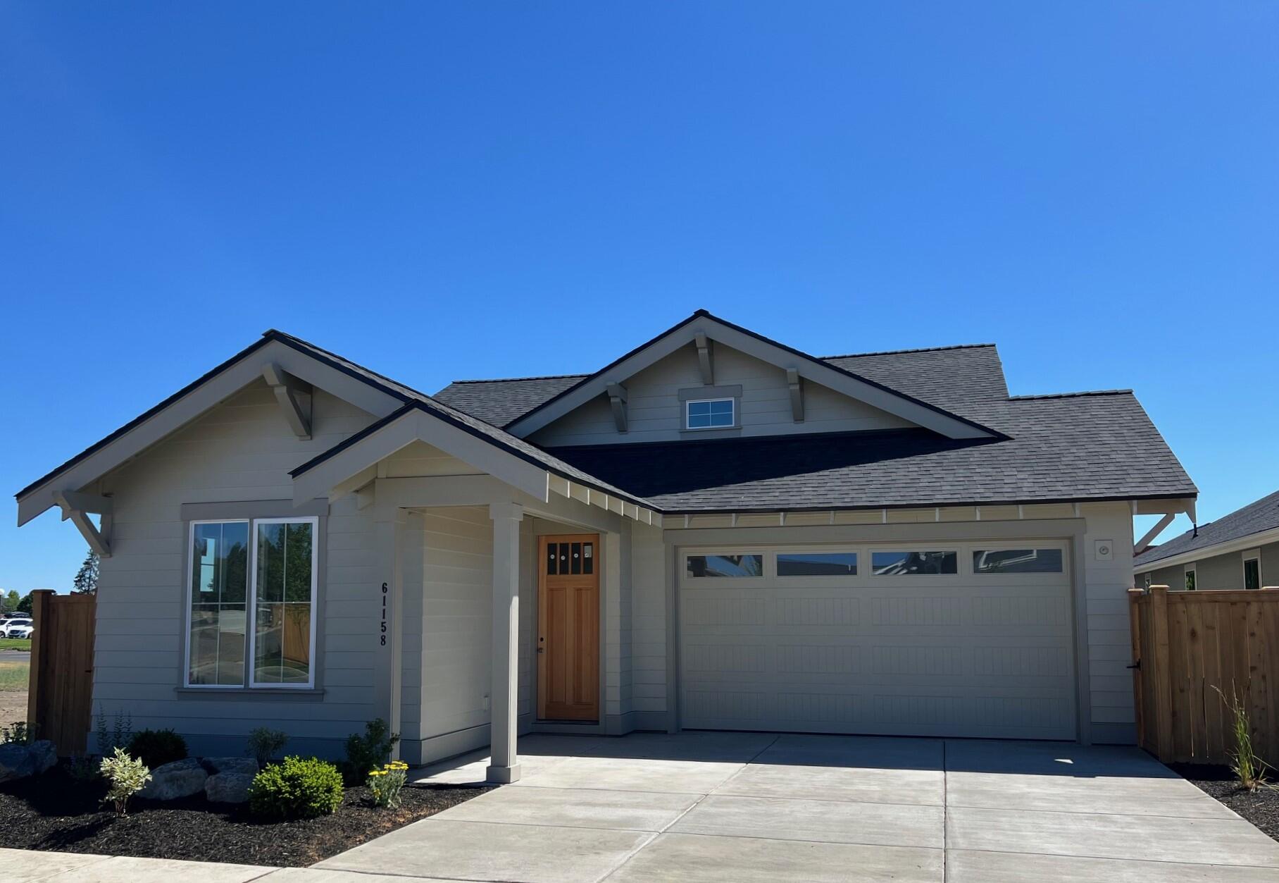 Winner of 8 Tour of Homes Awards including Best of Show, Best Value, Best Kitchen and Best Design. This fantastic single level SE Bend home sits on a manicured, low maintenance lot with a beautiful yard and view of the neighborhood. This home is loaded with features including epoxy garage floor and slat wall, custom paver patio, window coverings, central vac system, refrigerator, washer/dryer +more! The main level living includes kitchen, dining area, great room , two bedrooms + full bath, utility room with extra cabinetry and the primary suite with a tile shower, double vanity and custom closet package. The kitchen features solid surface counters, tile backsplash, island and stainless steel appliances. Modern engineered hardwood floors throughout the main living area. Sliding doors off the great room lead to a custom paver patio for convenient outdoor living space. Ductless heating system for year-round heating & cooling comfort. Cedar fencing and front/rear yard landscaping included