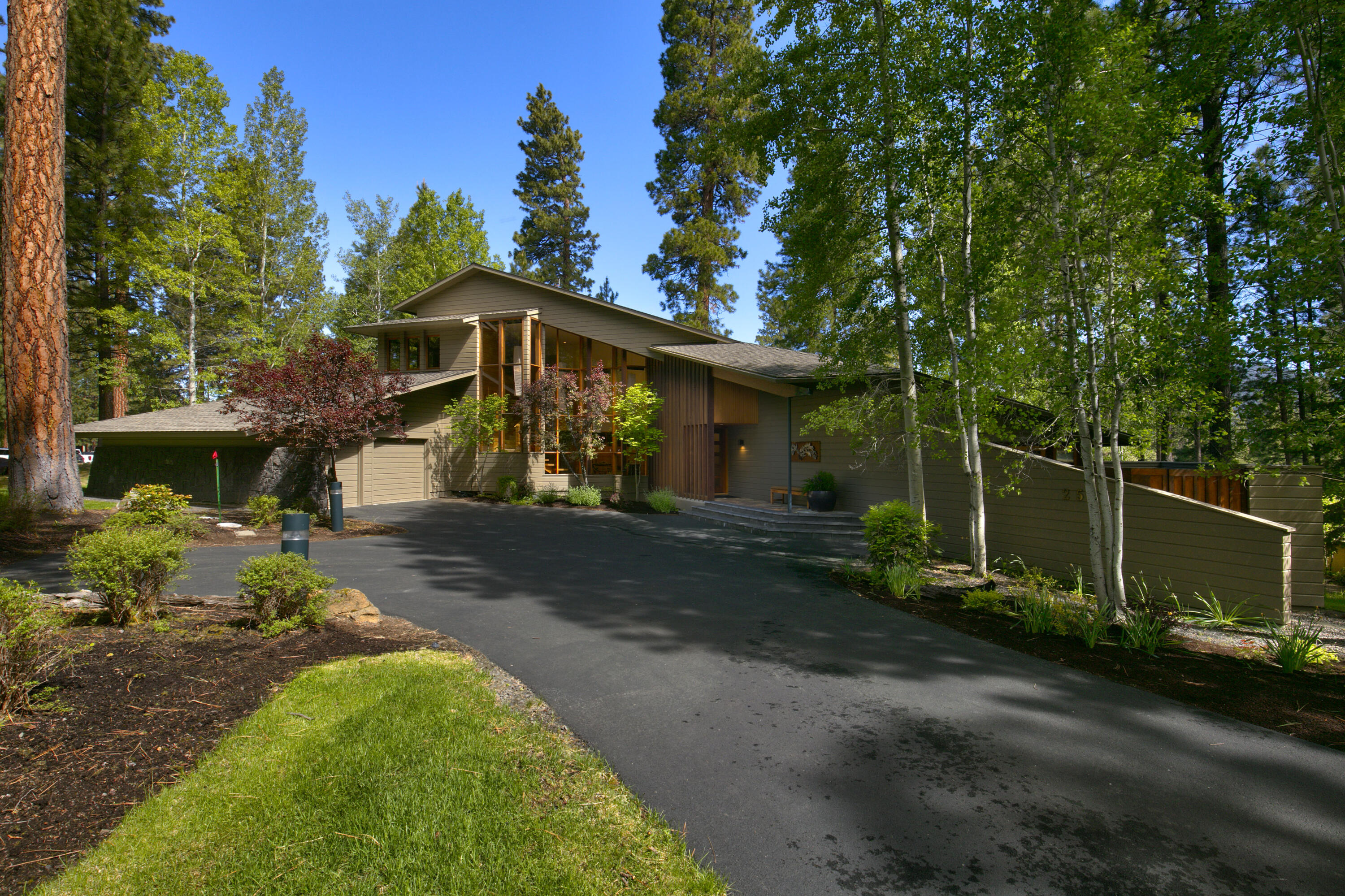 This exquisite Black Butte Ranch property located on the first tee of Glaze Meadow golf course is one of BBR's finest residences. Offering sweeping views of Black Butte and the golf course, the home features natural elements such as stone and cork flooring, stone countertops, cedar accents, and clear fir cabinets. A significant remodel was finished in 2010. The well-designed kitchen seamlessly flows into the dining and great rooms, enhanced by a wood-burning fireplace. The primary suite on the main level boasts a walk-in closet, a bathroom with heated floors, and an outdoor hot tub retreat. Additionally, the main level includes vaulted ceilings, an office/flex space with deck access, a TV/media room, and a laundry room. Upstairs, a loft and two bedrooms accommodate guests. Outside, a covered seating area, dining space, barbecue, and fire pit create an ideal setting for a peaceful living experience.