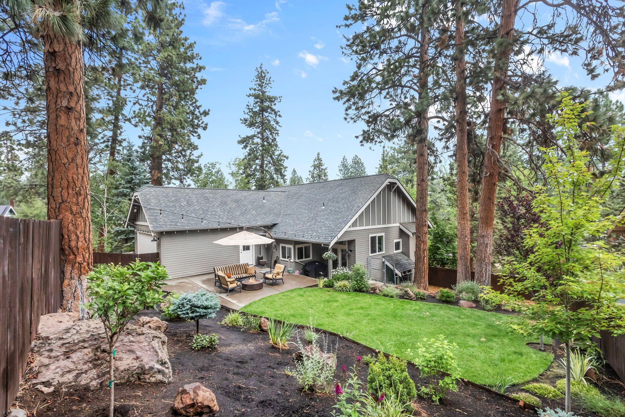 Discover this updated home in Bend's desirable Westside! Inside, the open floor plan features vaulted ceilings and large windows, creating an airy and inviting atmosphere. The great room includes a gas fireplace and hardwood floors that flow seamlessly into the dining area and kitchen. The kitchen is equipped with stainless steel appliances, ample counter space, and includes the fridge. Three bedrooms, including the primary suite, are conveniently located on the main floor. Upstairs, a spacious loft area offers additional living space, along with an extra bedroom and full bath. The large, fenced yard includes a generous patio area, perfect for outdoor gatherings. A double car garage with alley access adds to the home's convenience. Additional features include the washer, dryer, a whole house humidifier, a four-year-old roof, and fresh interior and exterior paint within the last two years. Agents-READ SHOWING INSTRUCTIONS.