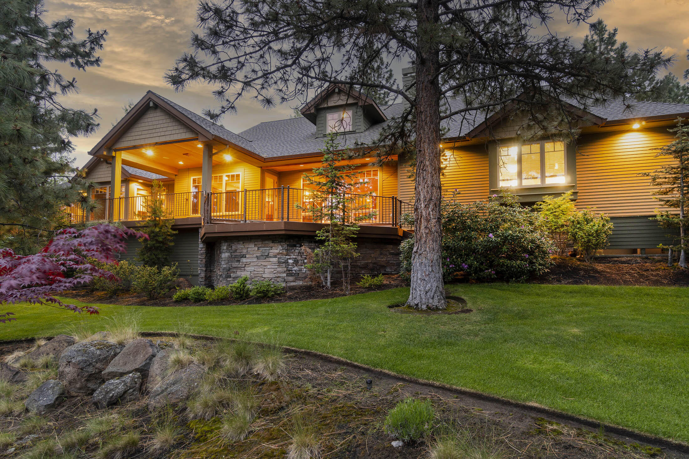 Privacy abounds in this custom-built single-lever stunner tucked among mature trees on Awbrey Butte. This finely appointed home features an open layout, vaulted ceilings, and wood doors, trim, and floors throughout. Enjoy high-end JennAir appliances, solar tubes, a built-in security system, and surround sound capability. An entertainer's dream with expansive decks to the west, accessible from the living room and owner's suite, this home boasts peekaboo mountain views and a stunning water feature that lights up at night. Don't miss the large three-car garage, complete with an electric car charging station, kitchen, and workshop area! Two full en-suites, plus lots of storage, and a beautifully landscaped yard add to the move-in ready appeal. Just around the corner from the community playground and park!