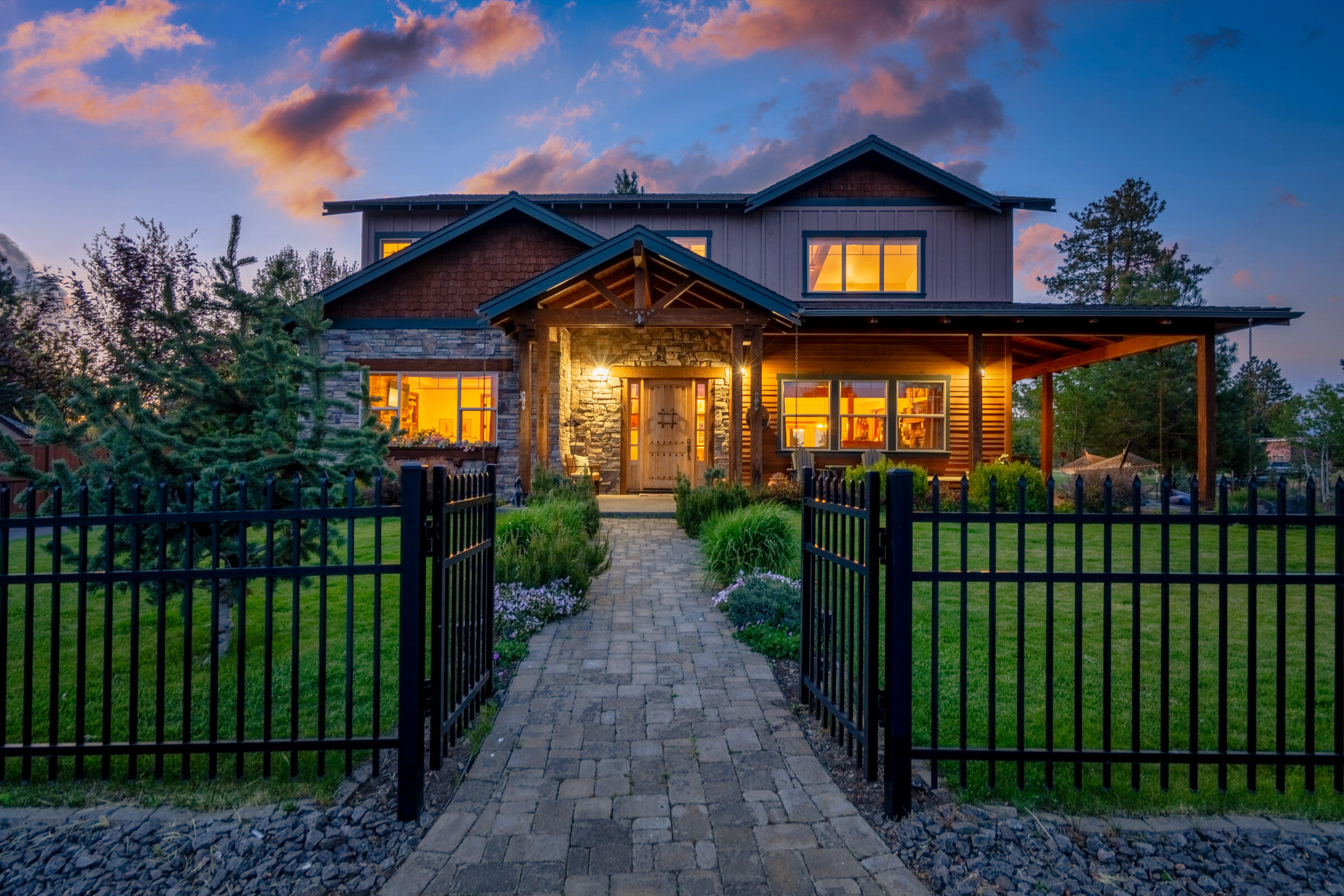 Stunning NW style on private .34-acre lot, fully fenced, water feature, & established landscaping, covered patio, 3-car garage. Attention to detail & quality are evident in this 4 bedroom, 3.5 bath, 3,775 sf home offering an open floor plan w/abundant natural light. The main level offers tile and hickory hardwood flooring, a luxurious primary suite complete with heated floor, cozy fireplace, spa like bathroom with jetted tub & tiled shower, custom closet with built in cabinetry & stack washer/ dryer. The great room offers ease & flow of indoor/ outdoor entertainment, floor to ceiling rock fireplace & a chefs' kitchen with top-of-the-line appliances, double ovens & solid surface counter tops. Upstairs features a bonus room with lovely views of the Cascade Mtns, bonus room with fireplace & built-in bookshelves, and a wet bar. Additional Master suite and two generous size bedrooms, upstairs bedrooms have Cascade Mtn views, walk in closets, full bath & Laundry room
