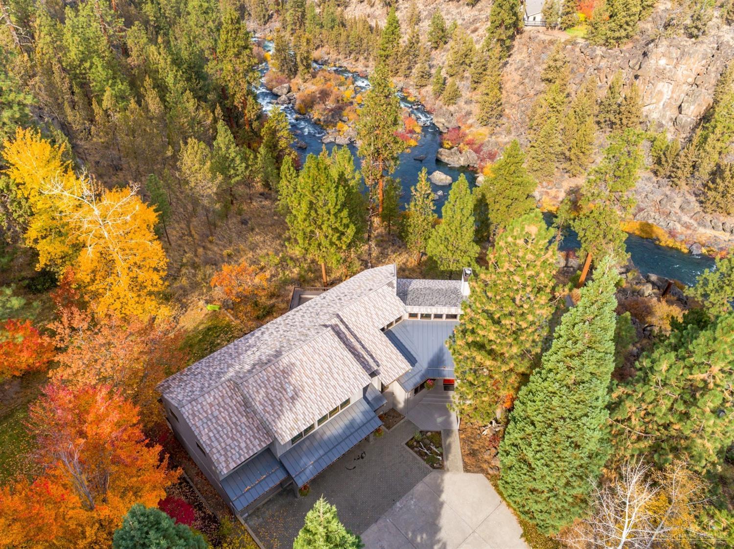 Breathtaking Deschutes River and river canyon views! Enjoy a tranquil setting perched atop rock outcroppings and surrounded by beautiful mature pines with excellent river access to miles of fishing and hiking along the Deschutes. Only minutes from downtown Bend, this light and bright contemporary home features a gourmet kitchen with high-end stainless-steel appliances, island and casual dining area, separate formal dining, large living room with stone fireplace and vaulted ceilings, and a spacious great room. Gorgeous master suite complete with fireplace, his & her walk-in closets, double vanity and dual walk-in shower. Additional space includes 2 guest rooms, 2 office spaces and a large 3-car garage. A must see on a private lot with flat grass yard and an expansive deck overlooking the incredible river views.