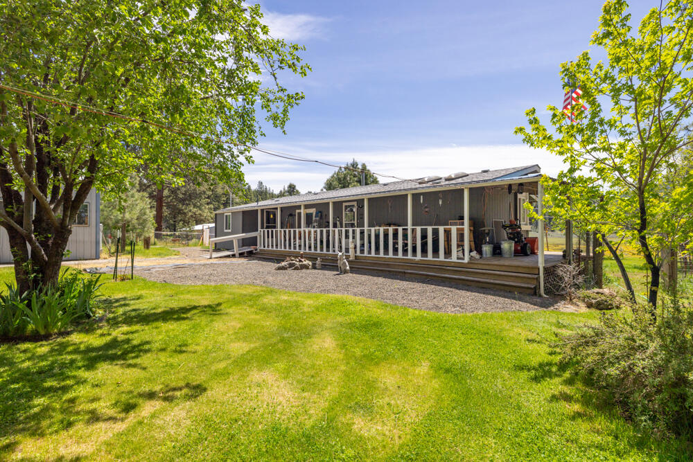 This beautiful property is about 5 miles west of Keno on Hwy 66 and has so much to offer. The large detached garage/shop is 60'x35' with an additional 18'x35' hobby room attached with a pellet stove and air. There is also a 18'x20' carport out front and a pole barn that is 35'x24'. Out back is a fabulous 60'x30' barn with a tack room and four large stalls, great storage for hay and any farm animals or equipment you may need. The manufactured home has over 2000 sq ft of living space, an inside laundry room, and a mudroom with an additional refrigerator and chest freezer. The kitchen has new flooring, a new wall oven and cooktop, new hardware, and new lighting. The roof is about 6 years old, the septic was replaced in April 2024. The inside of the house has been painted and well-maintained. This is a must see for the horse enthusiasts; there are miles of trails on this