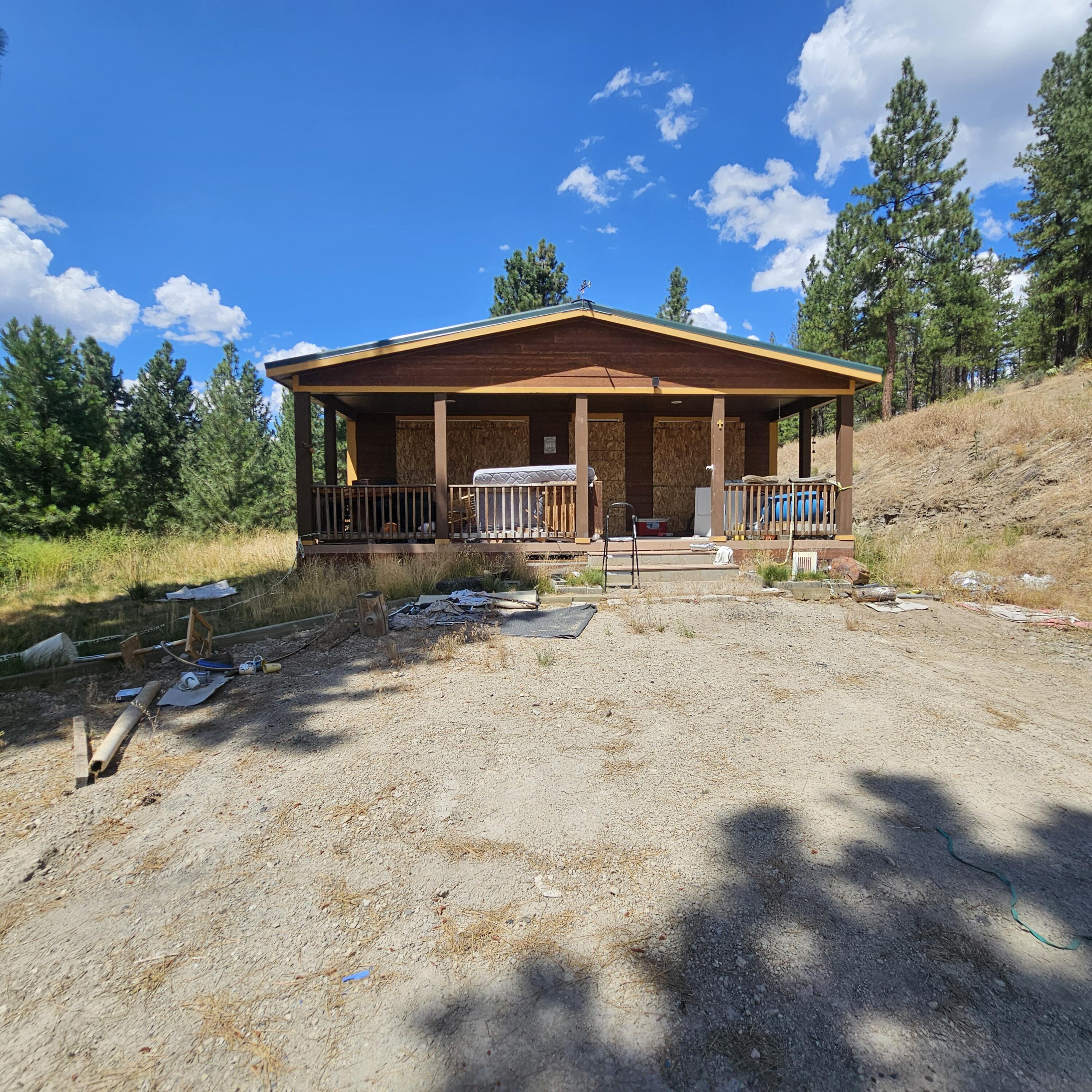 Property being sold as-is. 2-bedroom, 2-bath manufactured home with an office on a 27.81-acre fenced lot and well house. Nestled among the pines with natural landscaping. Kitchen has tile flooring; laminate flooring runs throughout the living room and bedrooms. Vinyl windows throughout. Both bathrooms have tile floors; the primary bathroom includes a soaking tub and a stand-alone shower. Well requires electrical connection. Home needs TLC, including furnace, water heater, front and back doors, and cabinets. Buyer to conduct their own due diligence regarding condition. Some walls may show visible damage. Property may require professional cleaning or remediation.