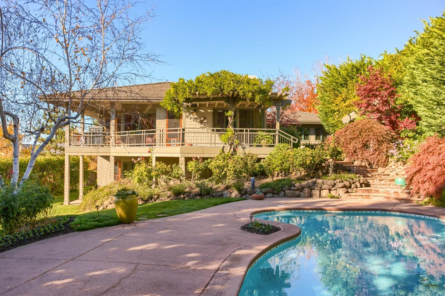 Exceptional quality custom home w/expansive views of the Rogue Valley. Award winning landscape design welcomes you to a well thought-out, spacious, & open 4,441' SF 4 bed, 3.5 bath home - could be featured on pages of Arch. Digest or Better Homes magazines. Located on .43 acre lot, exclusive & highly desirable neighborhood in area of high end homes. Perfect for entertaining, light/bright cust. Kitchen, SS appliances, incredible built-ins, pantry, breakfast nook, open dining w/fireplace, dry bar, rich Jara wood flrs., warm wood finishes & color tones, high ceilings, 2 living areas w/2nd fireplace, lrg. covered patio, hot tub, cust. pool, lush landscape, & peaceful setting. Luxurious main level master suite is spacious retreat w/fabulous views w/everything you would expect & more. Display art in natural light of gallery hall, den/office w/built-in cabinetry/work station, lower level family room. 4 bdrms-all spacious/2 bdrm. suites, amazing storage - additional 871' improved basement.