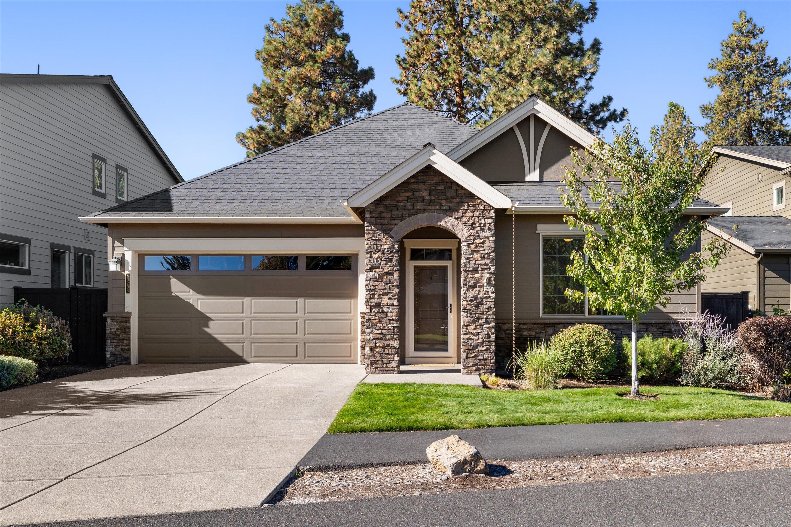 This meticulously enhanced single-level home blends elegance with functionality, feeling more spacious than its footprint suggests. Rich new hardwood floors
throughout, complemented by custom built-ins in the dining area. A striking floor-to-ceiling stone fireplace serves as the centerpiece, flanked by beautiful built-in cabinetry for both storage and display. At the heart of the home is a chef's kitchen designed to impress, featuring double ovens, a professional-grade cooktop, and high-end finishes that make cooking and entertaining effortless. The low-maintenance backyard is ideal for relaxing or gathering, with an extended patio, gas hook-up for a natural gas fireplace and BBQ, as well as a tranquil water feature. Low maintenance landscape allows time to enjoy all that Bend has to offer. Located in the desirable Stonegate community, residents enjoy amenities including a swimming pool, clubhouse, walking trails, playgrounds, and HOA-covered front yard maintenance and snow removal.