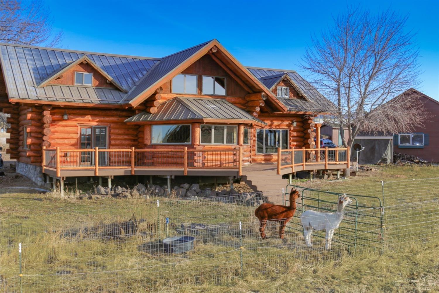 This beautiful custom log home was featured on HGTV's 'Log Cabin Living' as the premium Log Home choice of the current owner. This hard to find large acreage is located within Redmond's comprehensive plan for residential development. Features dynamic Cascade Mountain Views, Large Barn w/ room for stalls. Includes a Shop, Garage, Shed, Hay Storage, Auxiliary Buildings, irrigated pastures, fenced and cross fenced. Home has hardwood floors, granite counters, central A/C, wood burning stove, extensive decking, large Master w/ private balcony & more. A must see!