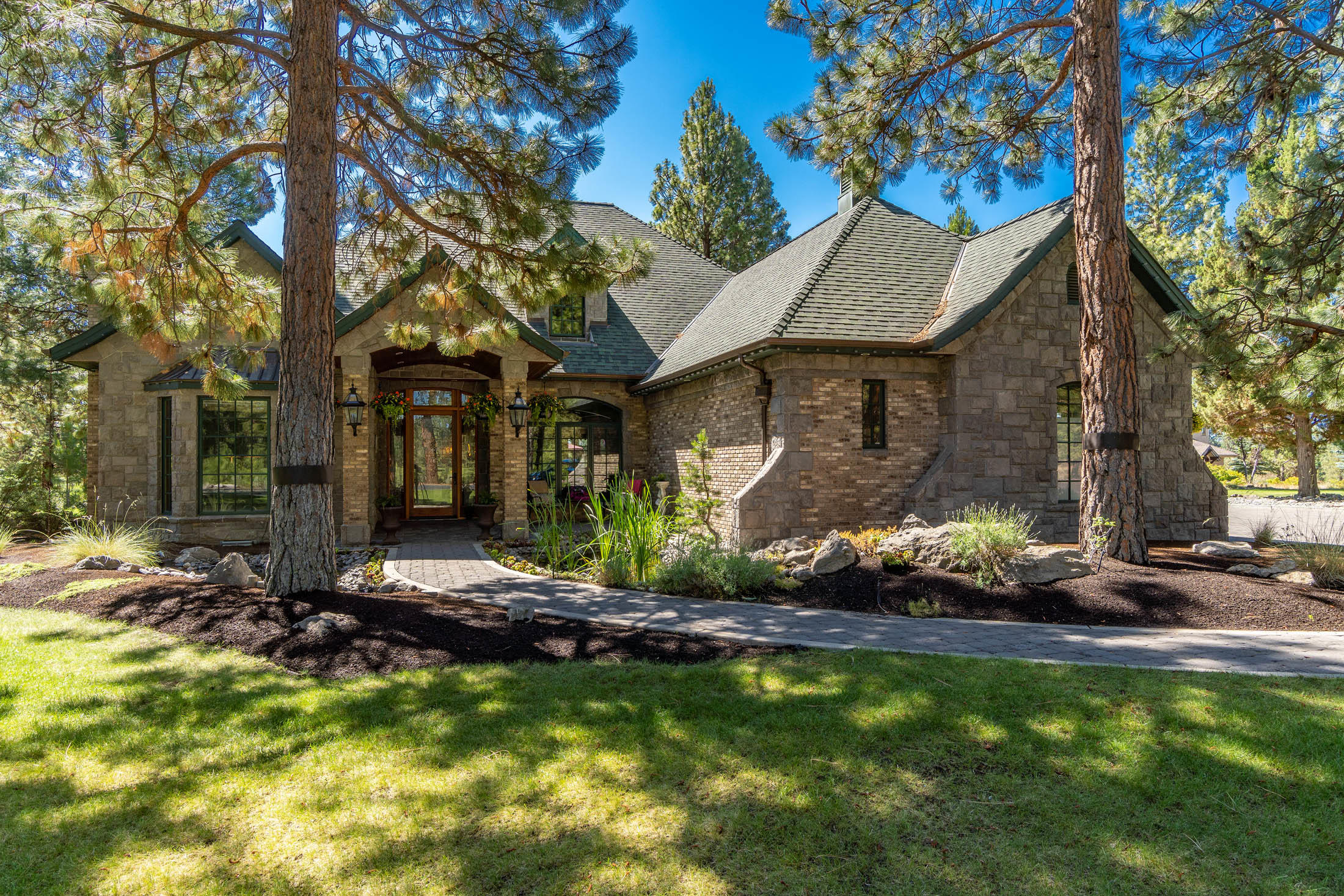 Beautiful custom home designed and constructed by local developer utilizing the highest quality materials & finishes.  All stone & brick low maintenance exterior, with views down the 3rd fairway (par 5), and Sisters Mountain range.  Over an acre of manicured landscape, nestled in the desirable gated Aspen Lakes community, a short walk to the club house community pool & amenities.   This home boasts 4 large bedrooms and 4 ensuite bathrooms + half bath, +5 fireplaces!  No expense was spared, with custom Koa wood floors, custom mahogany millwork, and natural stone materials throughout.  
Large wood burning fireplace equipped with gas starter & hidden wood storage pass through, built in surround sound throughout the home.  Large theatre room upstairs is projector ready and includes wet bar.  Master bath features large soaking tub, custom open air shower, as well as 2nd stackable washer/dryer closet.  Must see to appreciate. Broker is related to Sellers.  Tour: https://vimeo.com/435994244