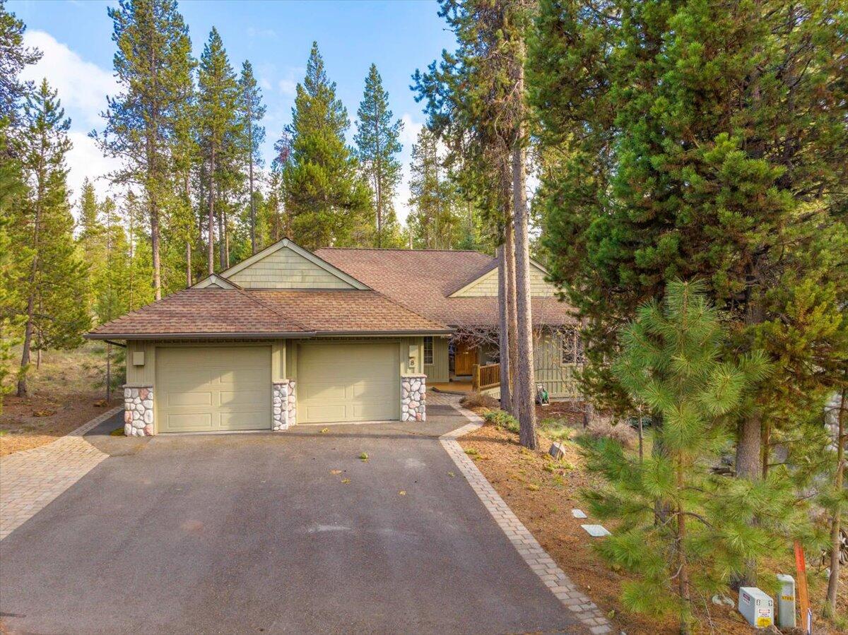 Welcome to this delightful home conveniently located in the desirable northern end of Sunriver Resort! With an open floor plan this makes a wonderful gathering space for family and friends. This remarkably clean, turn-key furnished home has 4 bedrooms including two primary suites separated with privacy by a large communal area and also has 3 full bathrooms. It boasts great curb appeal and is tucked into a nicely treed and quiet cul de sac. The large deck backs up to a shared green space and features a hot tub and a lovely place for entertaining.