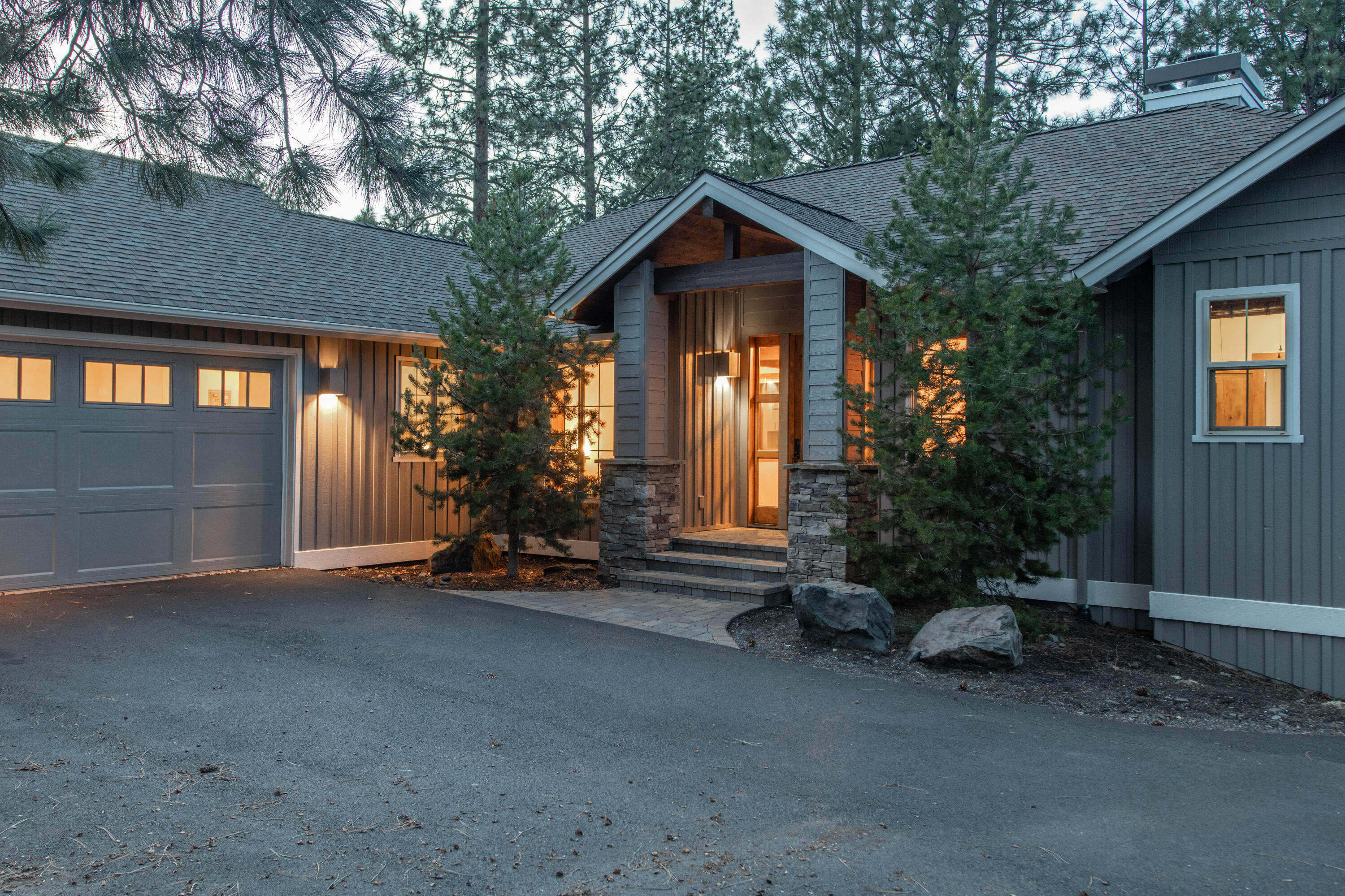 Custom-built by Pacwest Homes and located in the prestigious community of The Reserve at Broken Top, this stunning property overlooks community open space with public trail featuring direct access to Phil's Trail system. The open floorplan is anchored by the vaulted great room with wood beam accents, a stacked-stone floor-to-ceiling wood-burning fireplace with custom wood mantle, built-in speakers and access to the enlarged deck with stairs to the backyard. The upgraded kitchen features built-in fridge/freezer, newer white cabinetry, full-tile backsplash & white quartz countertops. The primary suite sits on the east wing of the main level, with the finished basement featuring two guest bedrooms, a full bath & a large bonus room with access to the private, screened hot tub. Topped off with a 3-car garage with a storage nook for your toys.