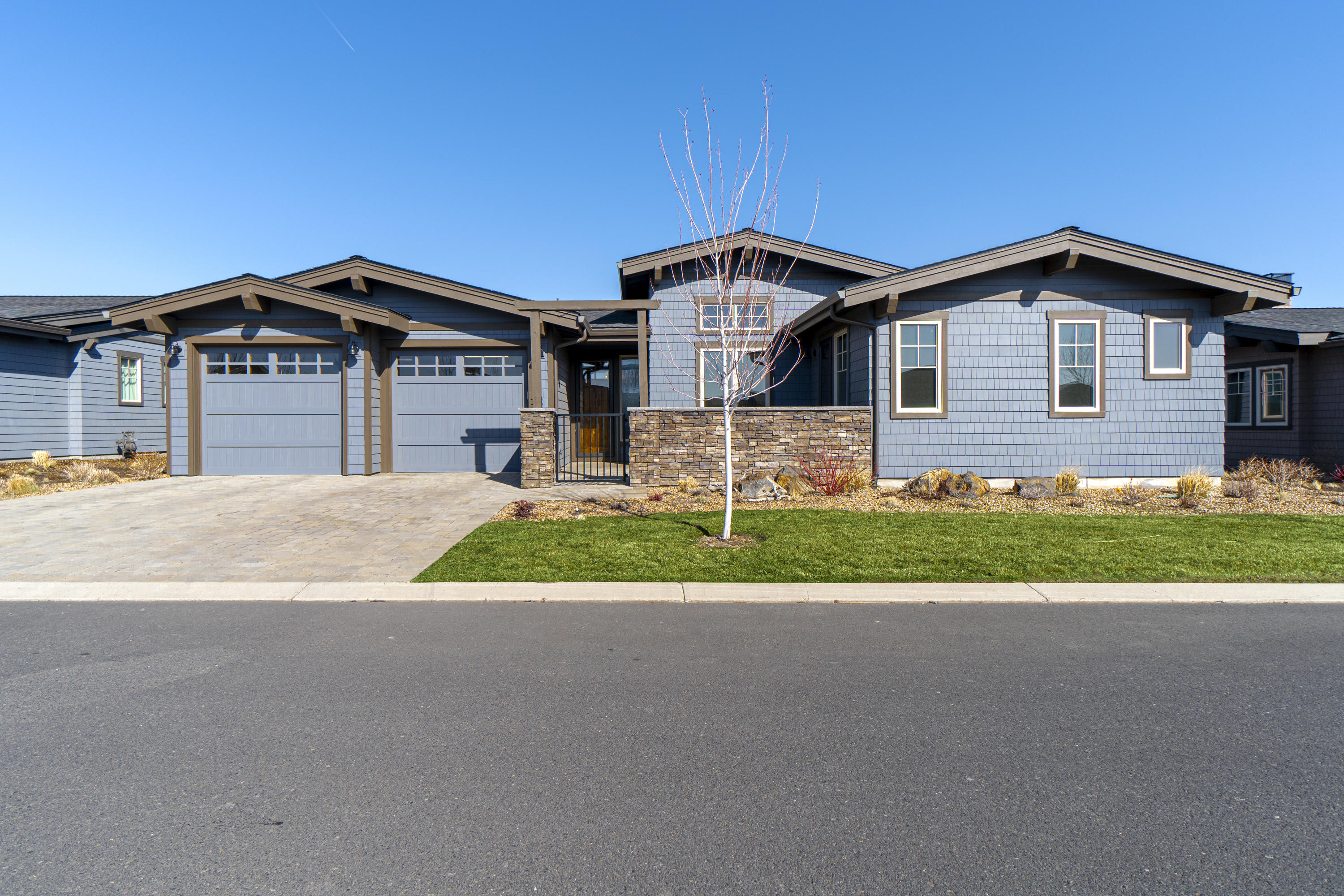 Desirable, Mountainside floorplan, single level home in the Tetherow Rim neighborhood. Gated courtyard with separate entrance to third bedroom. Spacious great room floor plan, centrally located den and large covered patio off main living area. Loads of upgraded features include beautiful Acacia floors, stacked stone gas fireplace and custom dry bar with cabinetry. Chef's kitchen features Thermador stainless steel appliances, large island with leathered granite counter and walk-in pantry. Spacious master suite has gas fireplace and luxurious en suite. Some mountain views, private back yard facing greenbelt and large, south-facing 3-car/tandem garage with built-in cabinetry. This home lives very comfortably and is impeccably maintained, feels like new! Nicely located close to the clubhouse, swimming pools and miles of recreation trails. Social membership initiation fee is included in sale! Buyer required to pay one-time transfer fee for membership.
