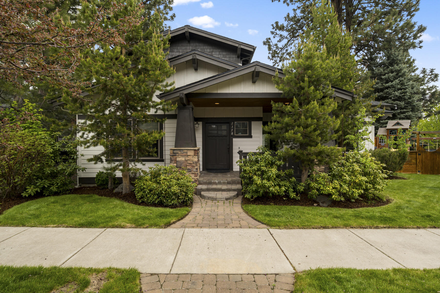 Stunning Custom Home in NW Bend's Shevlin Ridge. Discover this exquisite 4-bedroom, 3-bath, 3,594 sqft craftsman, perfectly situated on a corner lot and close to schools, shopping, trails, and more. Expertly constructed by Spring Creek Home Builders, this residence boasts manicured landscaping and a charming covered front porch. Step inside to an open great room floor plan featuring vaulted ceilings with ceiling fan, gas fireplace with stone hearth and built-ins, hardwood floors, and abundant natural light. The gourmet island kitchen is a chef's dream with slab granite counters, stainless steel appliances, a huge pantry, and dining area. Meticulously maintained, the second story offers a spacious primary suite with a luxurious bath, including a tiled shower, soaking tub, and double vanity. Large bonus room adds versatility to this beautiful home. Amazing outdoor living that includes a paver patio, inviting pergola, and is fully fenced—perfect for entertaining. Call for a showing today