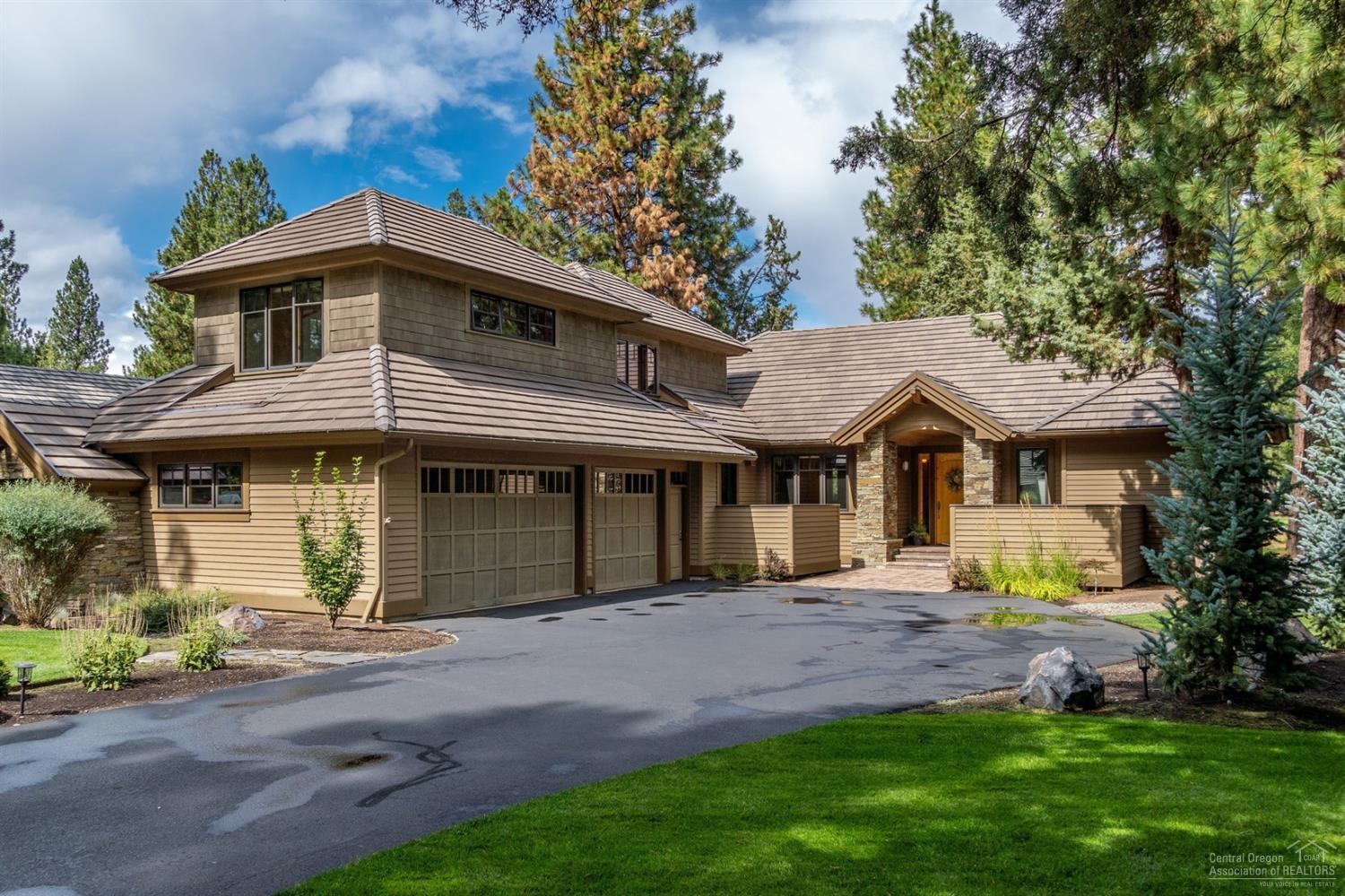 This open, airy home situated among the pines in Broken Top is a breath of fresh air. From the moment you enter, you'll feel as though you're in a Northwest retreat. Slate and hickory floors, and knotty alder accents throughout are a constant reminder of the quality craftsmanship of this Pacwest home. Featuring two masters on the main level, this 4BD, 3.5BA home is thoughtfully designed for mostly main-level living. The back patio overlooks the 3rd hole of the award-winning Broken Top golf course, and is perfect for entertaining with a fire pit, hot tub, and built-in grill. This home also features an office with built-ins and a 3-car garage with shop area and epoxy floors. Live in one of Bend's most exclusive luxury communities, and enjoy amenities like a putting course, swimming pool, tennis courts, fitness center and restaurant. Come enjoy the Central Oregon lifestyle at its finest.