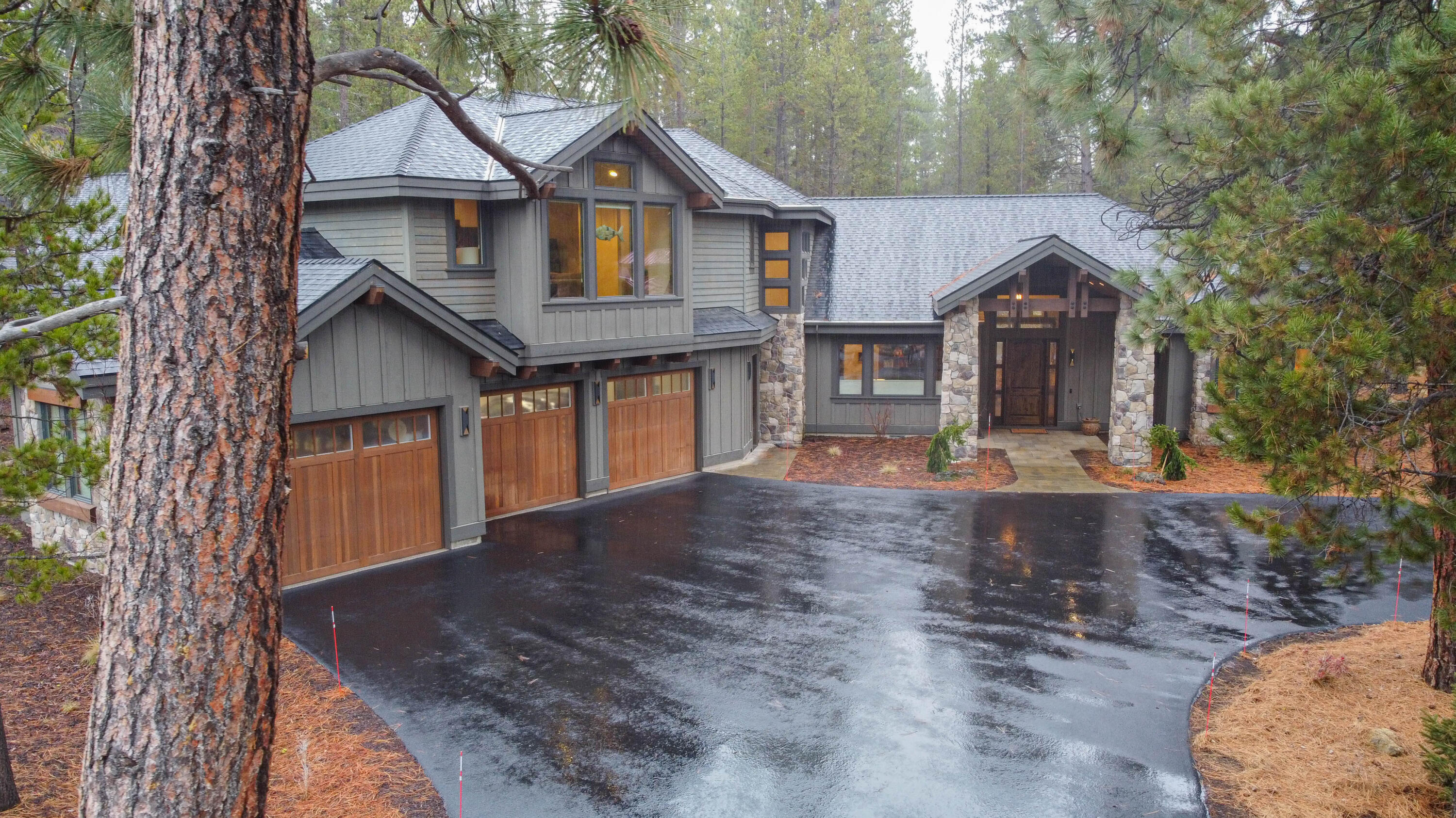 Fabulous contemporary design style enhances the overall sense of luxury in this custom Northwest lodge-style home located in Caldera Springs. With 5 en-suite bedrooms + den & closet this home allows plenty of space to accommodate multiple families and guests.

The main floor features soaring ceilings, vaulted bedrooms, and a spacious great room adorned with a floor-to-ceiling rock fireplace and extensive wood beam accents. This creates a warm and inviting atmosphere, perfect for gatherings, entertaining and relaxation. 

Oversized windows in the bedrooms seamlessly connect the indoor spaces with the scenic forest, allowing natural light to flood the interior. The design prioritizes a connection to nature, making the most of the picturesque surroundings.

The outdoor living experience is elevated with a large south facing rear deck overlooking an abundant wildlife forest preserve. Extensive use of pavers, privacy fencing, and large covered patio off the great room and primary bed
