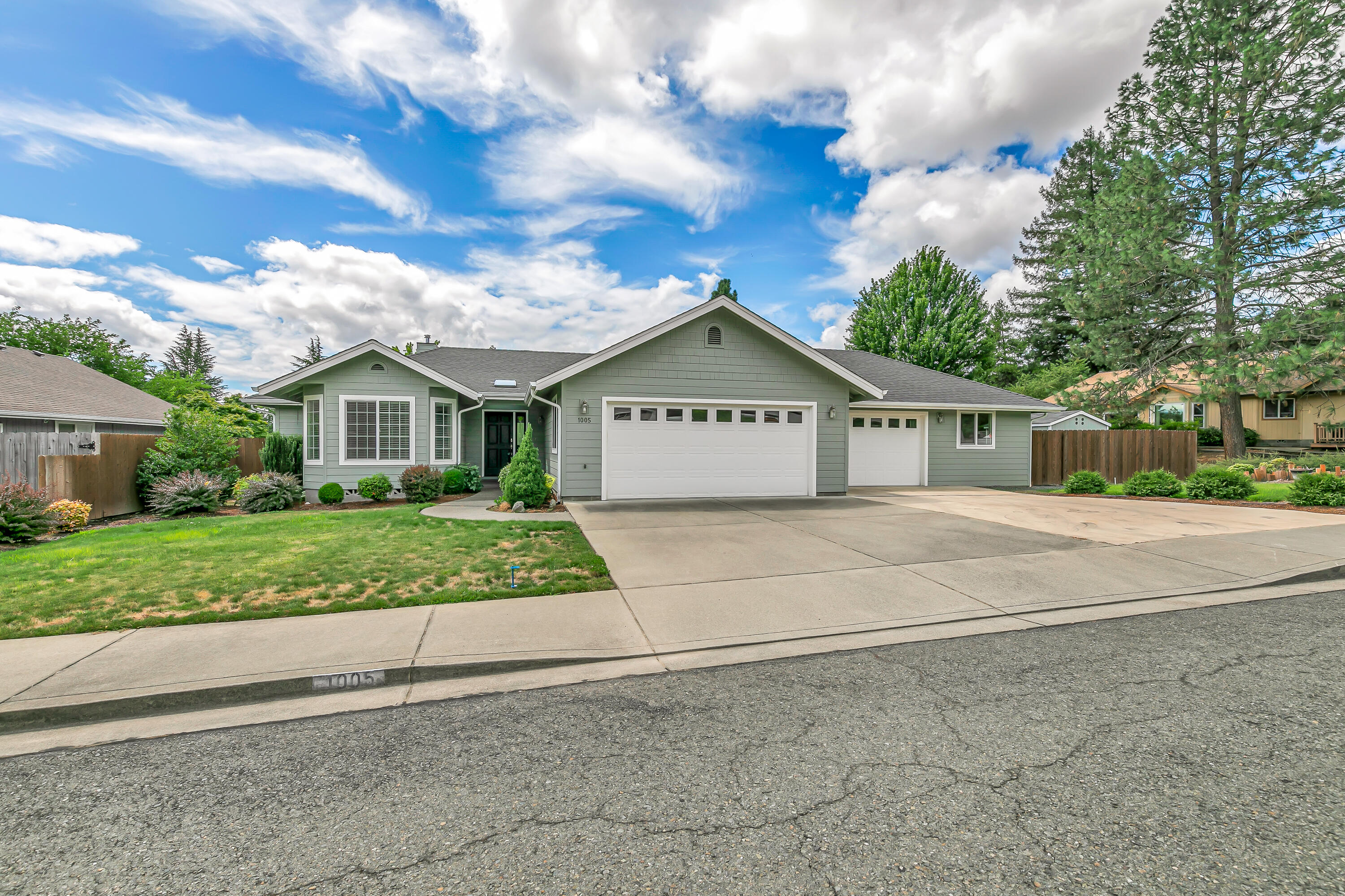 This stunning 3 bedroom 2 bath home offers 1,732 sqft of beautifully crafted living space on a well manicured .32 acre lot. Vaulted ceilings and a gas fireplace create a bright, welcoming feel the moment you walk in. The kitchen features sleek granite countertops a large center island, and extensive cabinet space. The primary bedroom is a private retreat with a walk in closet, soaker tub and French doors that open to a covered patio, perfect for a small fire pit. The oversized 3 car garage provides generous space for vehicles, recreational toys and tools along with built in storage. Beautifully landscaped yard with in ground sprinklers and drip irrigation in both the front and backyard. With thoughtful features and plenty of space to grow, this property is ready to become your next move!