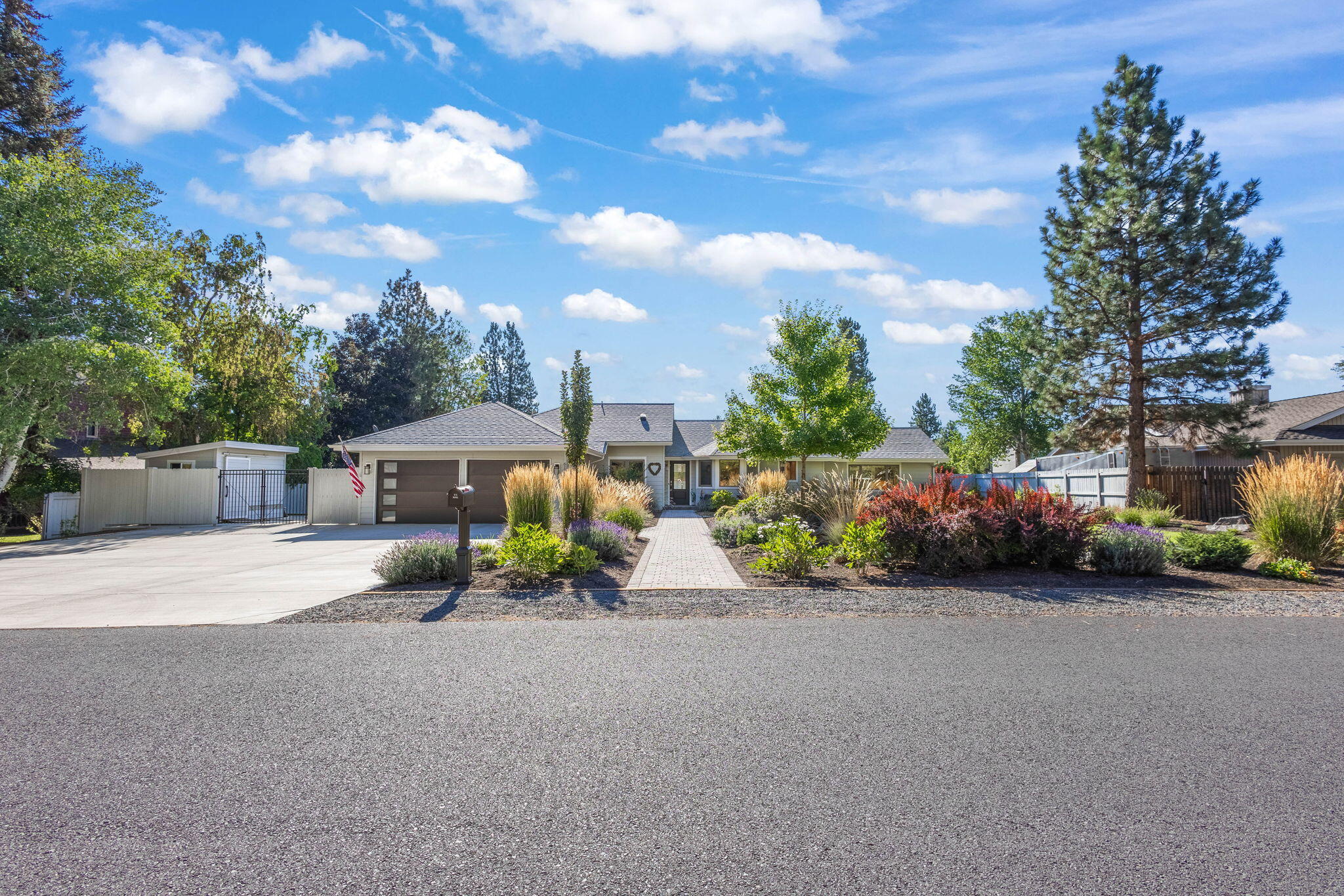 Discover this stunning beautifully renovated single-level home located in the coveted Orion Estates of SE Bend. Situated on a meticulously landscaped half-acre lot, this light-filled home boasts vaulted ceilings and custom Brazilian Mahogany cabinets that add warmth and elegance. The fully remodeled kitchen, equipped with top-tier appliances, is perfect for culinary enthusiasts. The primary suite offers a peaceful escape with its custom walk-in closet and luxurious ensuite. With an oversized two-car garage and RV parking, there's ample space for all your toys. Outside, enjoy a private backyard oasis featuring a spacious paver patio overlooking the canal, surrounded by vibrant perennials and mature pear trees. A nearby walking trail enhances the appeal of this home, which offers the perfect blend of comfort and convenience, close to schools, restaurants, shopping, and trails.