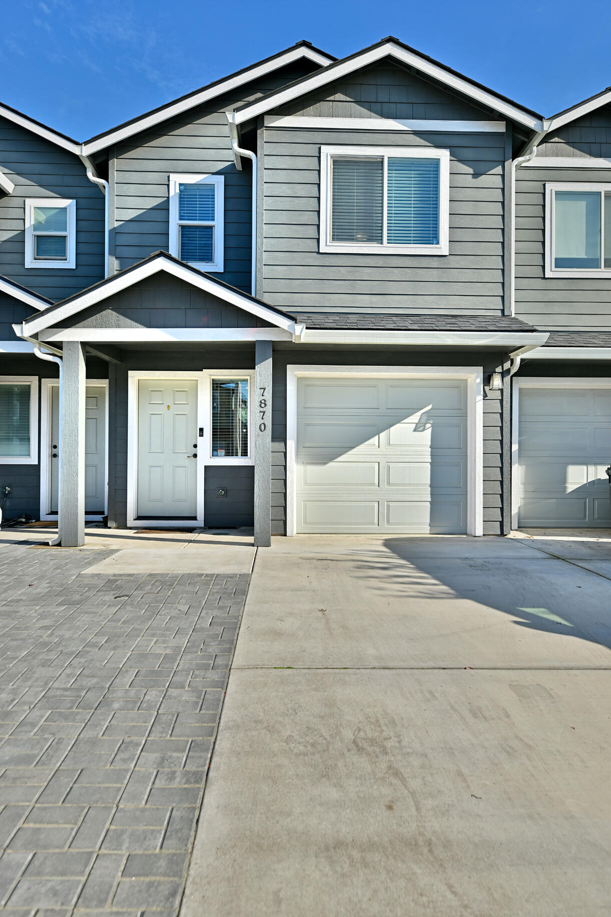 Experience the charm of this modern 2-bedroom, 2.5-bathroom townhome built in 2021. With 1,527 sqft, it features a spacious open floor plan and upgraded laminate flooring throughout. The kitchen includes granite counters and stainless steel appliances. Oversized bedrooms offer comfort, with tile bathrooms and tile showers. Laundry is conveniently located upstairs with the bedrooms. The fenced backyard boasts a pergola, turf, pavers, and rock for easy maintenance and entertaining. Extra parking area in front and single car garage adds convenience. A perfect blend of modern living and easy maintenance awaits you!