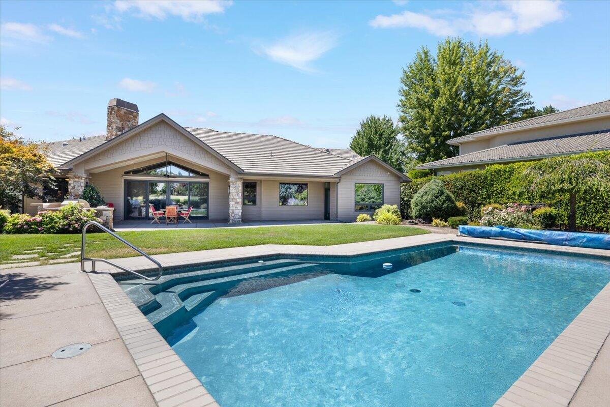 Here's a rare opportunity to own a home in the gated Island Pointe community on the 8th fairway of the Rogue Valley Country Club. This is a single story 3BR | 3BA home with 3325 SF of living space, there is a home office with french doors and a closet that could work as a 4th bedroom, a large over sized garage with room for 4 cars or use the extra space for your golf cart, updated kitchen and cabinets, a separate dining room, fireplace in the open living room off the kitchen, outdoor built-in gas kitchen, pool, large covered patio, bocce ball court and gardening space on a large .43 acre.