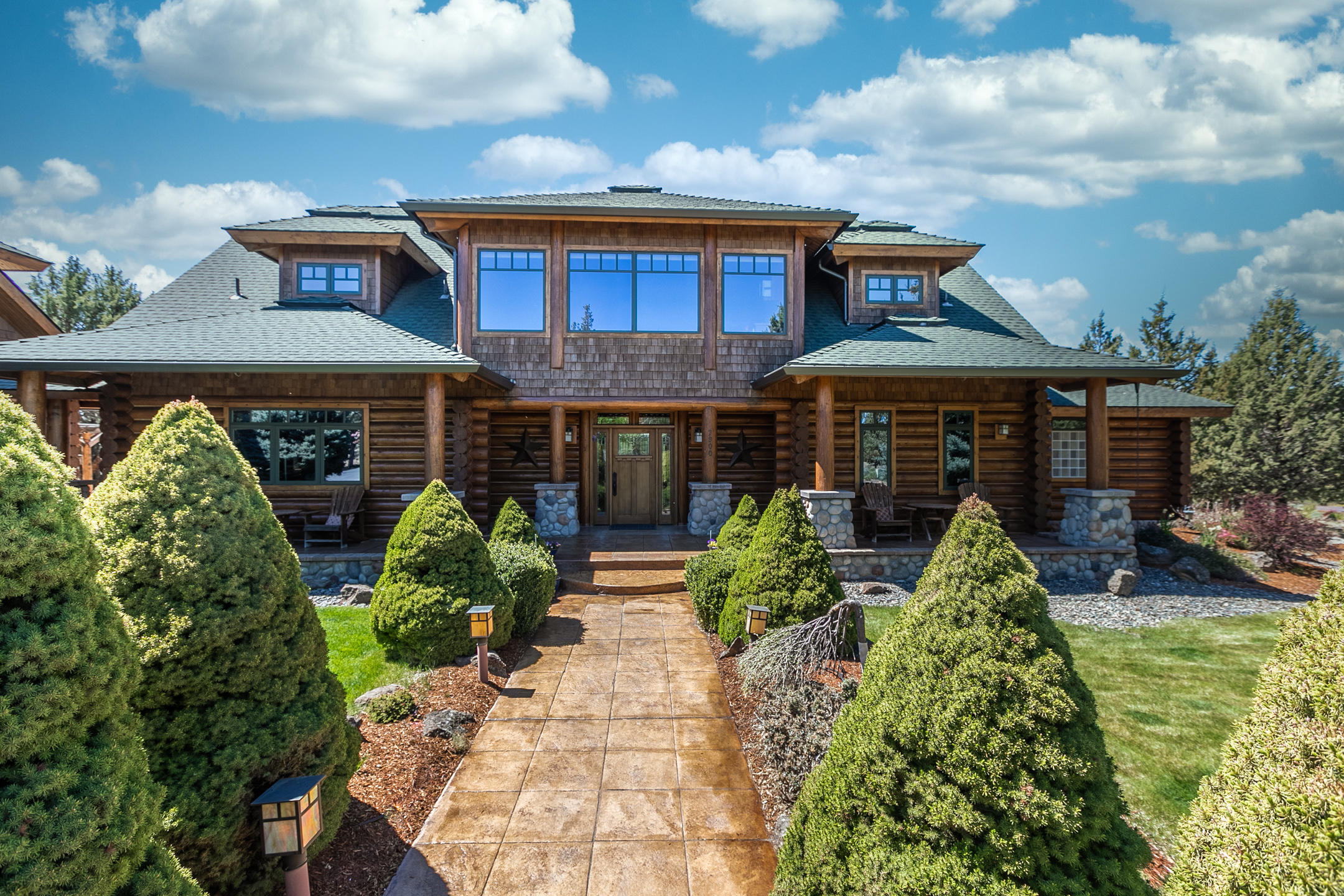This gorgeous custom log home gives you the best of both worlds - rural peace and gated-community privacy! 3,856 sqft plus 500 BONUS sqft with Cascade mountain views, and Deschutes river frontage, this one-of-a-kind property offers everything you could want out of Central Oregon living including fishing and floating from your own backyard. This home has been immaculately cared for and comes complete with top-of-the-line stainless steel appliances, quartz countertops, soaring vaulted ceilings, two gas river rock fireplaces, radiant floor heating, and more! It's just as impressive outside as it is inside with two stamped concrete patios, a gas fire pit, full outdoor kitchen, 10x10 covered spa, pristine landscaping, enclosed dog run, greenhouse - the list goes on! Truly an entertainer's paradise not to be missed! Check out video tour here: https://youtu.be/o0f7F-K2Omc