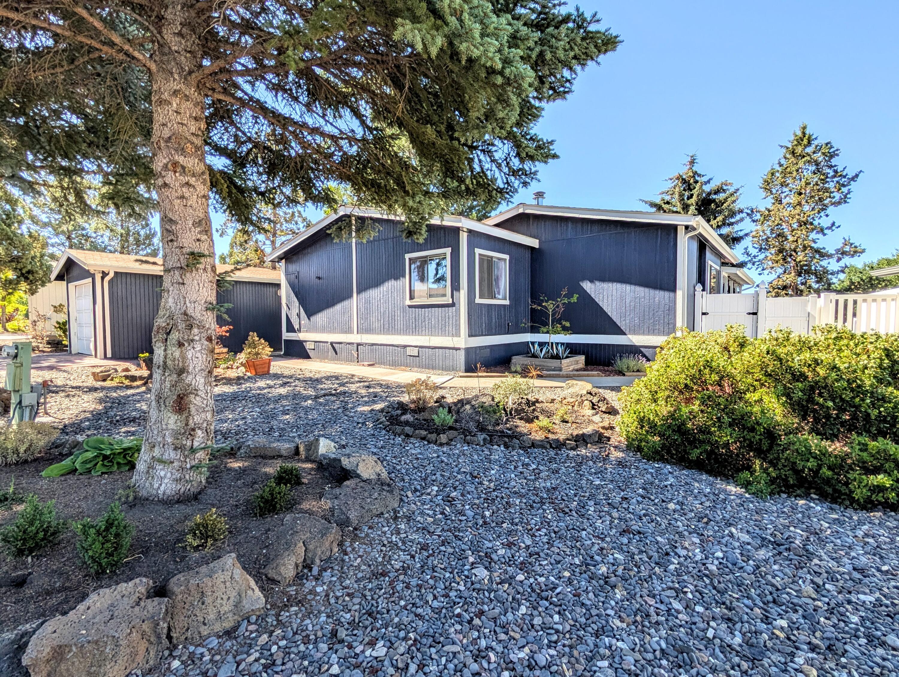 This home is in move-in condition and priced to sell!!  Located in 55+ Cascade Village MHP with a  short walk to the recently refurbished Clubhouse and its many activities. The exterior is freshly updated and has an enclosed area around the deck, perfect for keeping pets enclosed. Wonderful large covered porch with open views for enjoying nice days. Large open living area has an office alcove with a built-in desk and ample shelving, woodstove, and slider to the deck. The kitchen is remodeled with state of the art appliances and a large walk storage pantry nearby. The primary bedroom has a large walk-in closet, an additional closet and remodeled bath with double vanity, soaking tub and separate shower .The second bedroom and bath are located at the other end of the home. Large sunny utility / mud room with washer / dryer and sink has lots of storage and counterspace. So many fresh updates and an exceptional value - you must go see!
