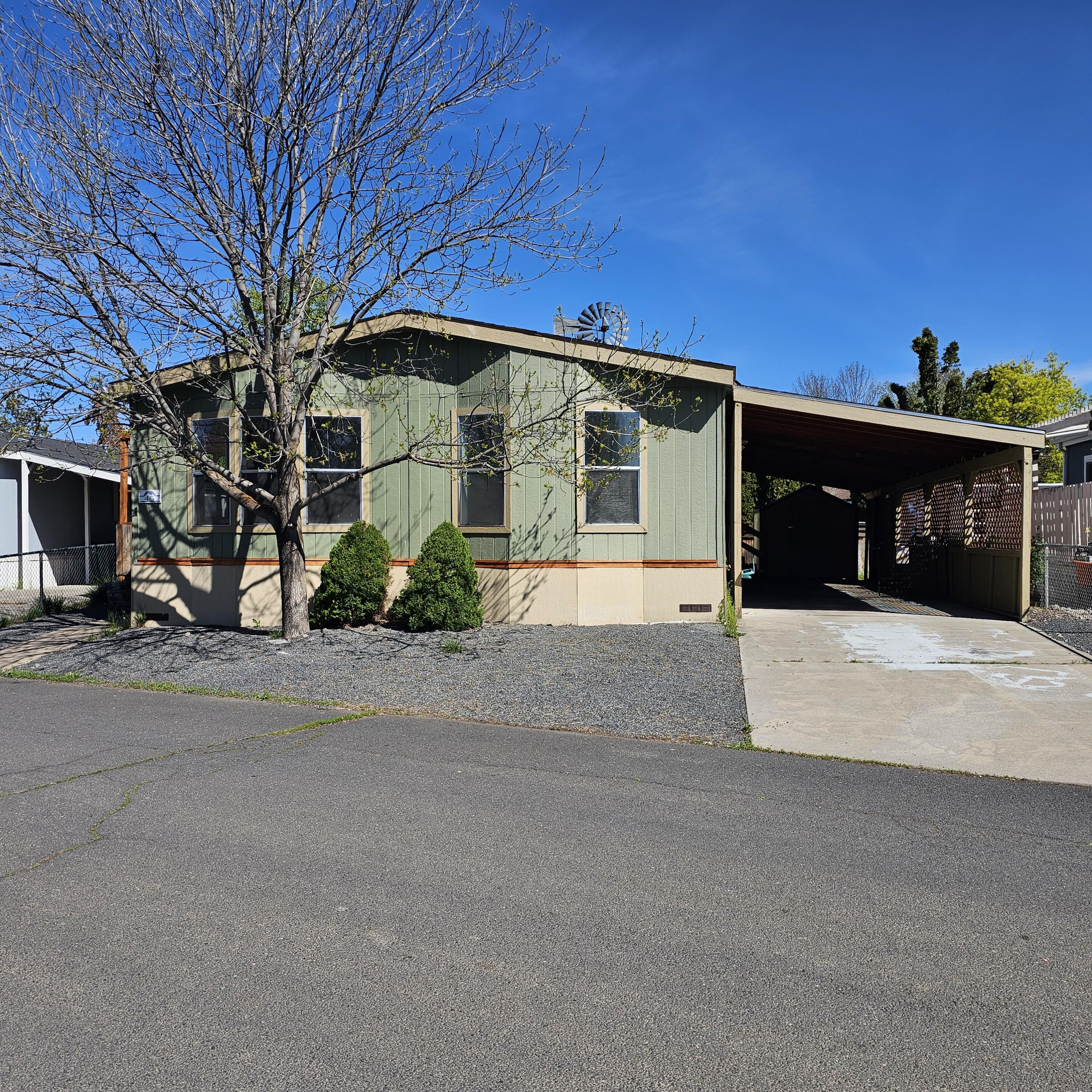 Spacious 3-bedroom, 2-bath manufactured home in a quiet park setting! With 1,620 sq. ft., this home features two large living areas, a dedicated laundry room, and a roomy primary suite with a generous bathroom. Recent updates include freshly painted walls, painted cabinets, new light fixtures, and luxury vinyl plank flooring in the dining room, bathrooms, laundry, hallway, and kitchen. Enjoy the convenience of a paved carport, a storage shed, and a small, low-maintenance yard. Plenty of room to relax, entertain, and make it your own!