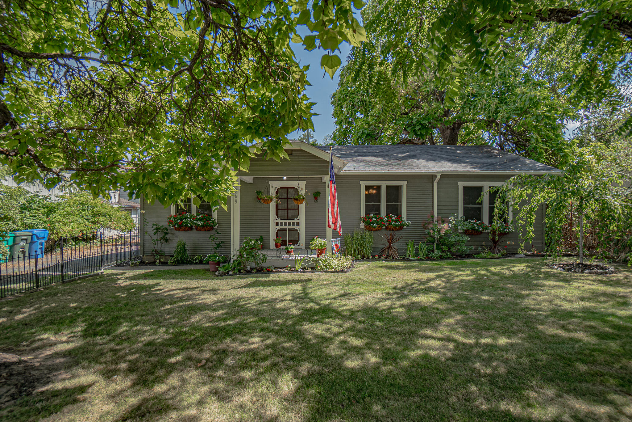 As you drive by this home, don't be fooled-this is a curb-appealing charmer!  The square footage is in the back of the house and the surprise is in the backyard! Multiple fruit trees, an antique chicken coop, mature shade trees and open space abound in this gardener's delight!  The inside of the home has a large open style kitchen and there is an oversize laundry room, where the washer and dryer are staying with the home!  There is also a refrigerator and a standing freezer that will remain with the property.  Close to shopping, schools and Asante Medical complex.