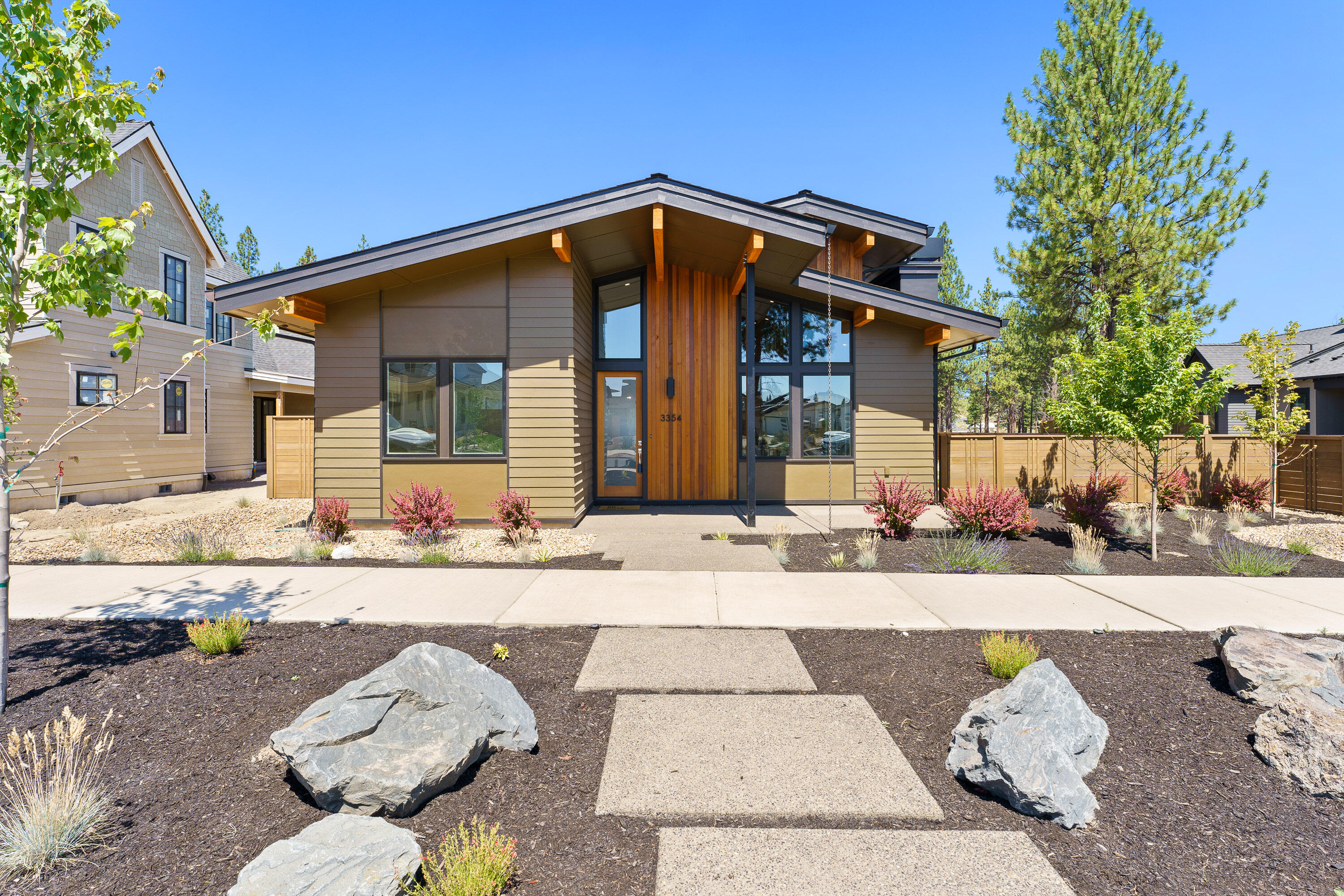 This fabulous Mid-century modern home in Northwest Bend is located in the much sought after Discovery West neighborhood. It's soaring ceilings, big windows  and skylights flood the home with light. With high end finishes throughout this beauty boasts three bedrooms, an office, a bonus room and a spacious three car garage with one bay to hold your Sprinter van or RV. Builder can add 1/2 bath at bonus room/office area at no extra cost to buyer. Discovery Corner, a vibrant community gathering place with small shops and dining, is just a short distance away.