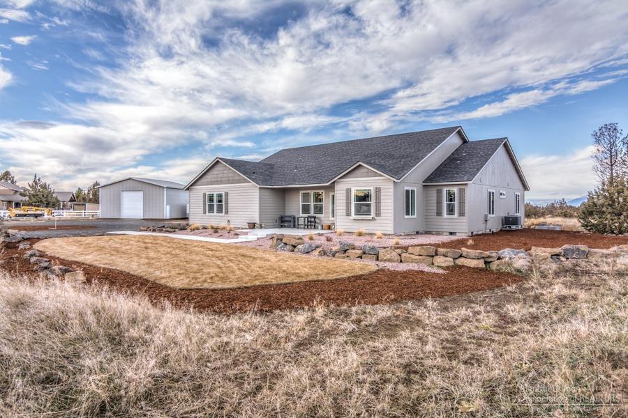 Newer home built in November of 2018. Home is on over 5 acres with 2.85 acres of irrigation, 36x36 shop. Beautiful single level 2486 sf, 3 bedroom, 3 bathroom, open living floor plan, with an additional office/den/formal dining room. Vaulted ceiling's in living area, barn wood laminate floors, white cabinets in kitchen with grey quartz counter tops throughout. Italian tile floor in bathrooms. Master suite has large walk-in closet, soaking tub and tile shower. Enjoy Cascade views from your peaceful back yard patio. Landscaped yard with sprinkler and drip system. New 40 gallon+ minute well. Shop has 12x14 roll up door with man door.