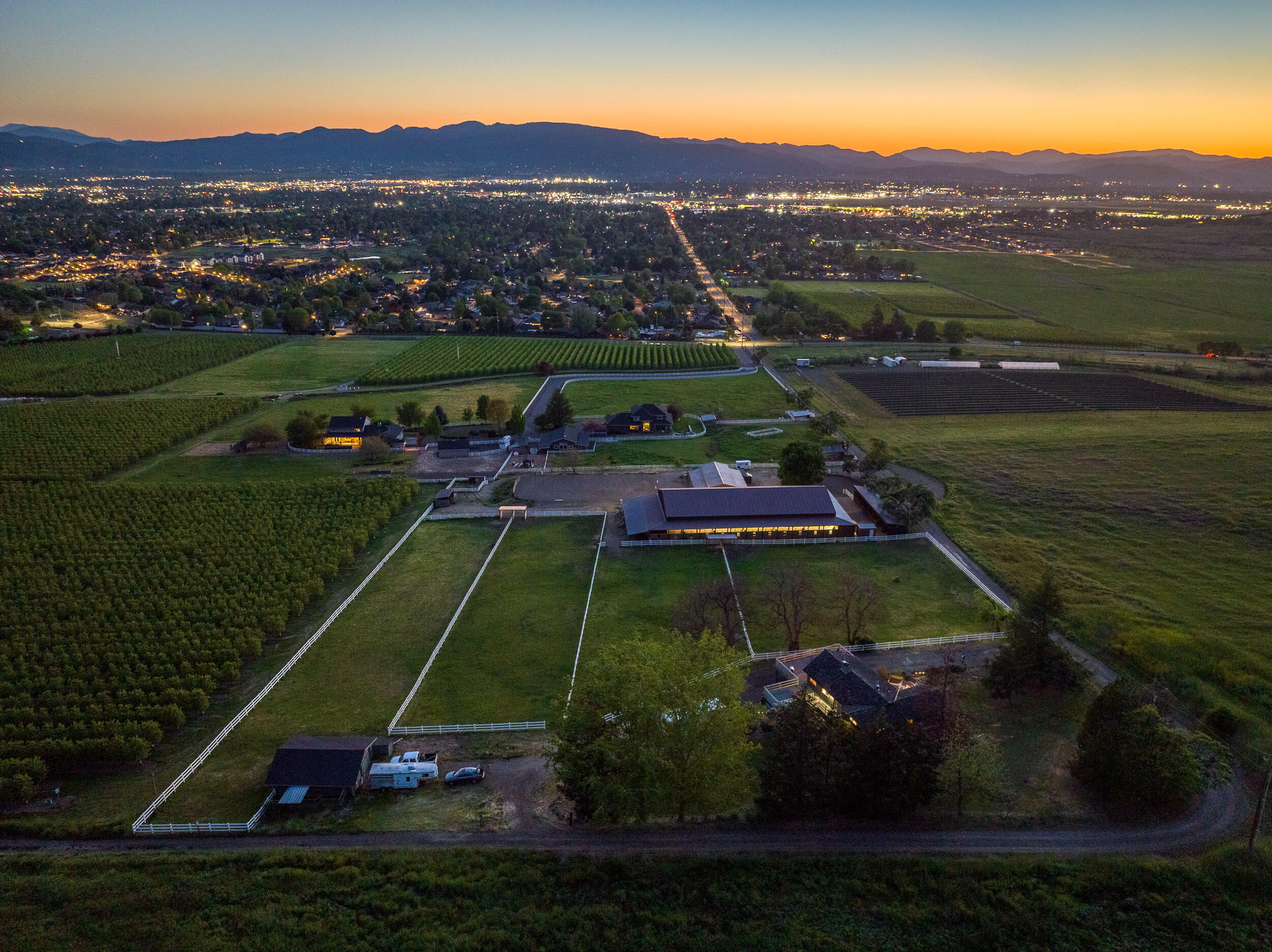 Welcome to Roxy Rose Ranch - Nestled amidst the rolling hills of East Medford, this 5-acre equine property offers a blend of tranquility, extensive equestrian facilities, a home with great views and a phenomenal location. With convenient access to Medford's business districts and being near the heart of East Medford's residential neighborhoods, this property offers the best of both worlds and could be a great canvas for an equine business.  The property would lend itself well to any number of business models including boarding, lesson plans, training, events or some combination of all four.  The facilities include over 25 stalls, 4 irrigated turnouts with shelters, indoor arena, outdoor arena and round-pen.  The entrepreneurial options combined with extensive infrastructure make this a great opportunity for the discerning buyer. The 2,400 SF home features a open concept floor plan with daylight basement, three bedrooms and two and a half bathrooms and a large deck.
