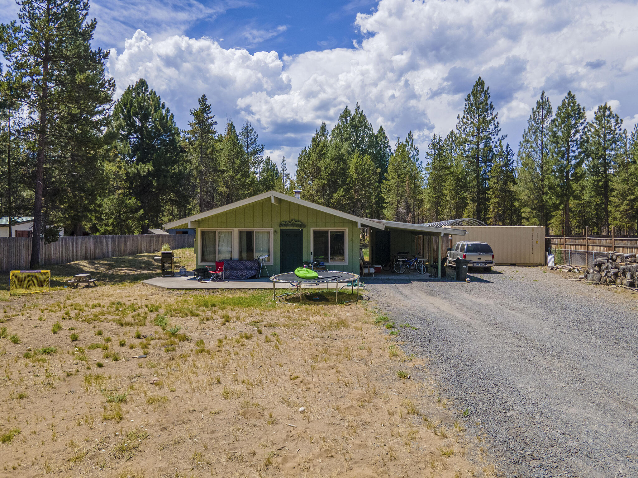 Looking for a peaceful escape or vacation home? This 2 bed, 1 bath retreat sits on a .52-acre lot, backing directly to BLM land for added privacy & access to wide-open spaces. The property is fully fenced & gated, ideal for pets, outdoor gear, or just peace of mind. Enjoy the convenience of a carport & storage shed, giving you plenty of space for vehicles, tools, & recreational equipment. The home features a 400-amp electrical service upgrade, with an add'l 200-amp subpanel available - ideal for a future ADU or shop. Though the home needs some updating, it's full of untapped potential, so bring your vision & make it your own! Located just down the road from private Deschutes River launch access, it's a dream spot for fishing, kayaking, or relaxing by the water. Whether you're seeking a weekend escape, investment opportunity, or full time home, this property offers a rare combination of location & value. *Interior pictures are old photos, interior may differ. New photos coming soon.*