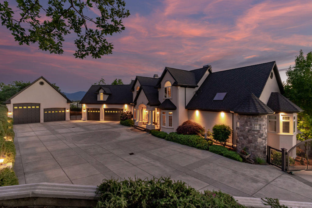 Custom elegant home offers spectacular architecture and design. Pagnini remodel with new master suite and master bathroom. Stunning views of the Rogue Valley and city lights. 5 bedrooms, 5 bathrooms 7832 sq feet on a large .86 acre view lot with in-ground swimming pool & mature landscaping. Gated entry, 3 car attached garage, 4 car/RV detached garages. Soaring 28' ceilings in the entry, floor to ceiling windows overlooking the pool & valley, fireplace, maple & tile floors. Custom kitchen with large island, stainless steel appliances, wine re-fridge, tile floors & fireplace. Master suite on the main floor, Office with built-in's, Theater room, 12X18 Safe room, Exercise room, Entertainment room with 2nd full kitchen & tons of storage through out. Security system, 4 zone HVAC system, full house surround sound, custom lighting and so much more!.