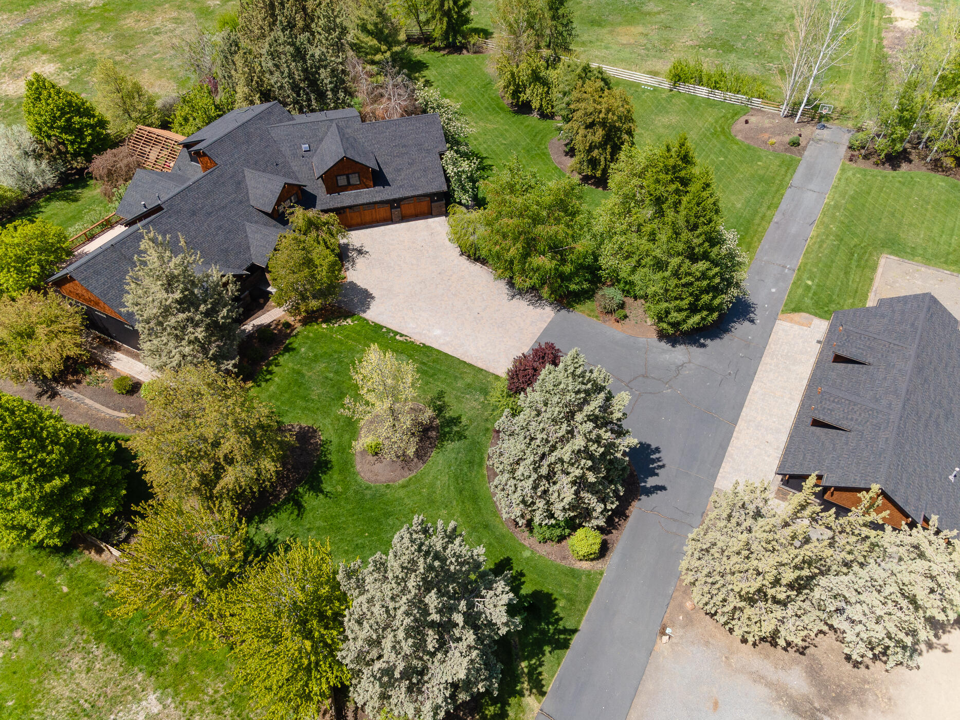 Private Gated Central Oregon Sanctuary on 19 Acres - Unmatched Quality & Space
Discover the perfect blend of privacy and luxury in this 4,801 sq ft estate set on 19 immaculate acres. Gated and beautifully maintained, this home offers elegant, country living with top-tier craftsmanship throughout. The chef's kitchen boasts an oversized butler's pantry, ideal for hosting or daily living. Enjoy a formal dining room, a main-level primary suite with office/library, and a dreamy laundry room. Upstairs includes a loft, two bedrooms with Jack & Jill bath, add'l guest rm, full bath, and a huge bonus room with kitchenette and pantry—ideal for guests or multi-gen living. The oversized 3-car garage also includes a full bath. There is a pole barn and a finished & heated 1,800 sq ft detached shop/garage with 5 bays and 9-ft cedar doors - a car lover's dream. Outside, enjoy mature landscaping, a spacious deck, and a fully irrigated pasture—perfect for equestrian use or serene living.