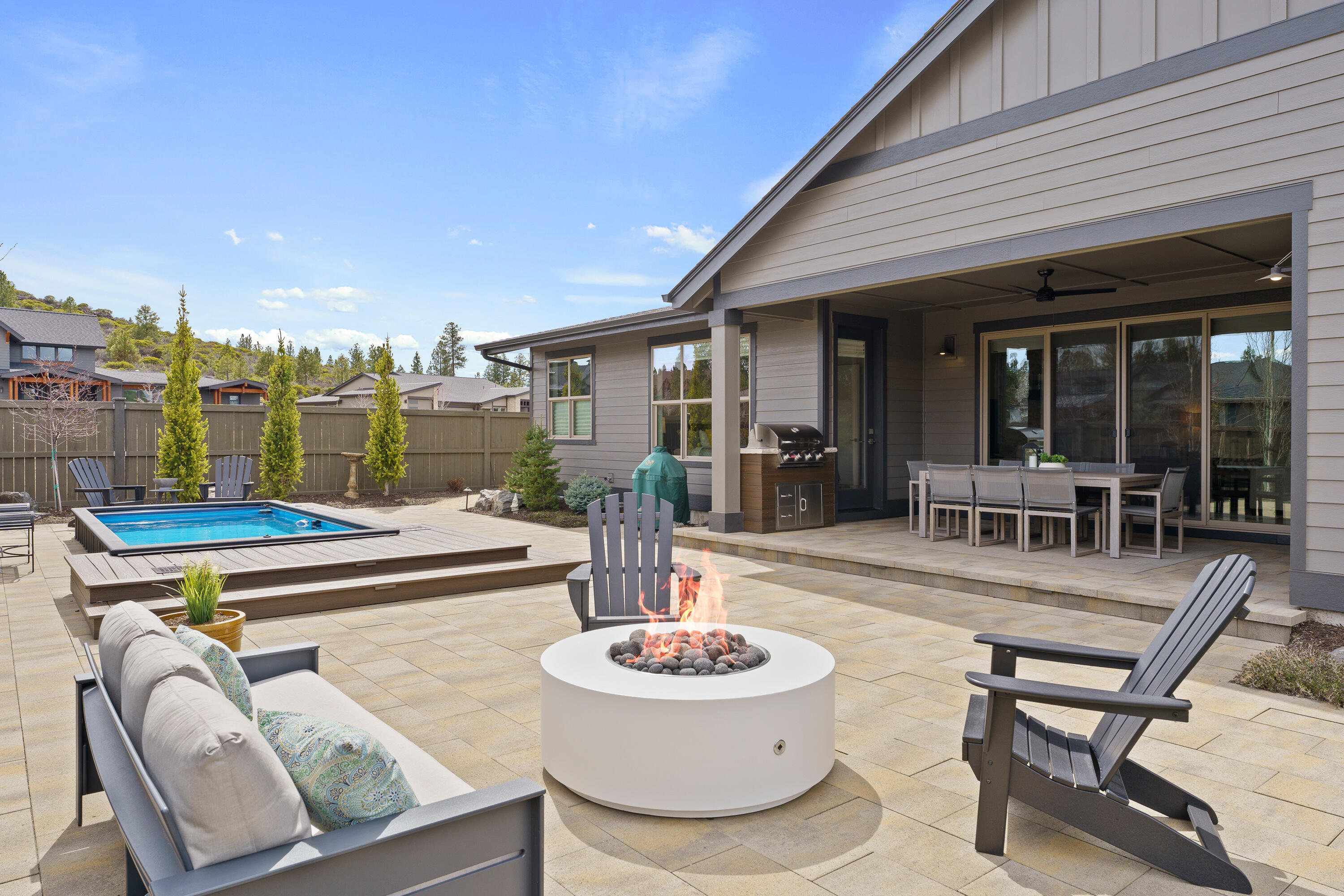 Contemporary Single-Level home on a quarter acre lot, located in SW Bend. The home offers a floor plan and finishes which are sure to please. In addition to the Primary Suite with walk-in closet; soaking tub and tiled shower; there is a Jr. Suite which would be perfect for guests and 2 additional bedrooms (or office space). The gorgeous chef's kitchen offers SS KitchenAid appliances; solid surface Quartz countertops; kitchen island; loads of storage plus a butler's pantry. Owners have recently painted inside and out and replaced dark wood floors with a lighter option. You will spend hours in the fenced and landscaped back yard which offers a covered patio; fire pit; and in-ground hot tub/cold plunge area. The River Vale community is close to river trails, biking trails, and shopping. You won't want to miss this gorgeous home!