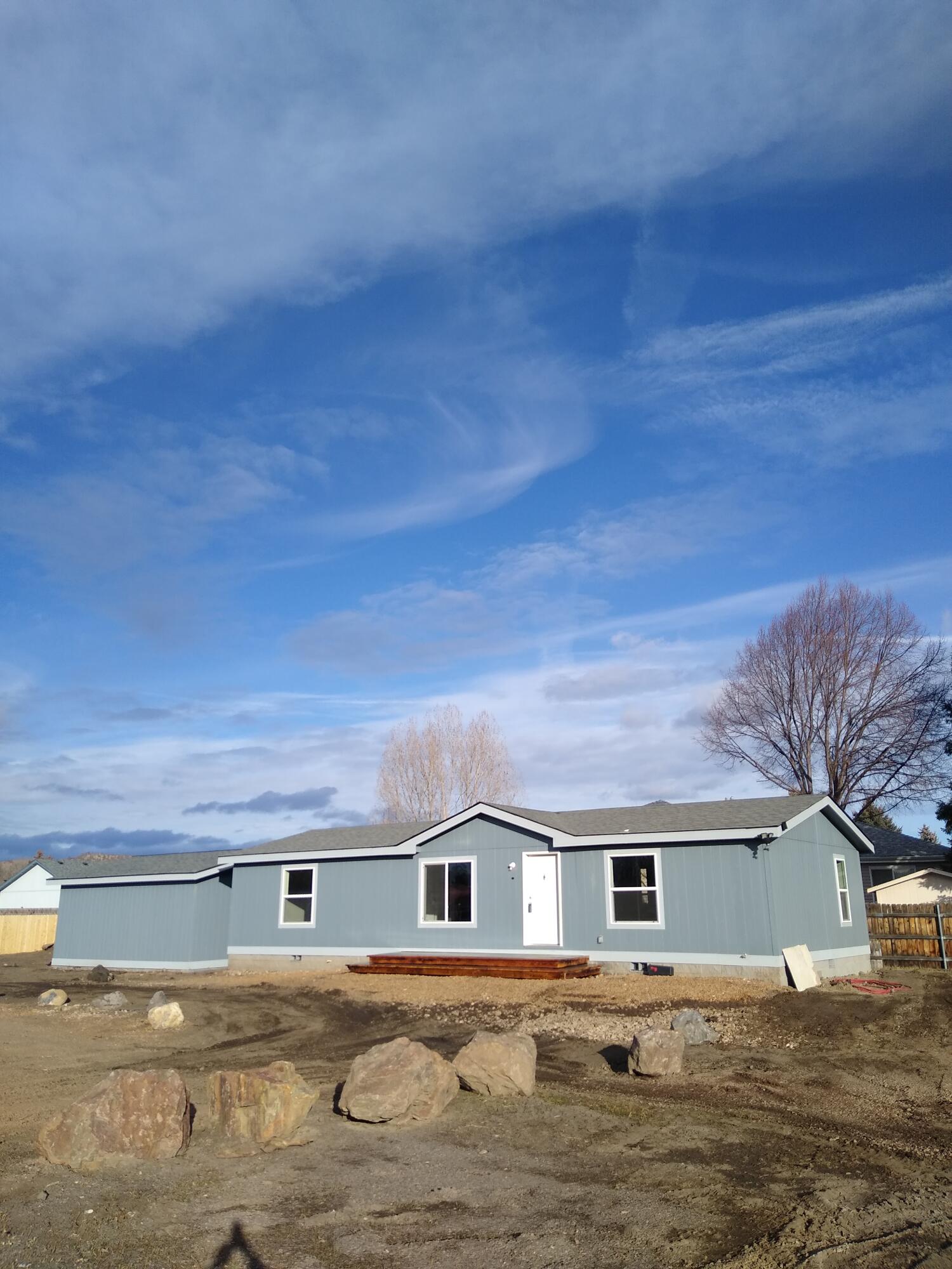 This BRAND NEW manufactured home is located in a quiet, desirable neighborhood close to downtown.  Spacious two-car garage with plenty of storage.  All three bedrooms have walk in closets.  Land on south and west of this property is owned by the city which allows you the feel of privacy and open space at the end of a cul-de-sac.  Plenty of room for your RV and other toys.