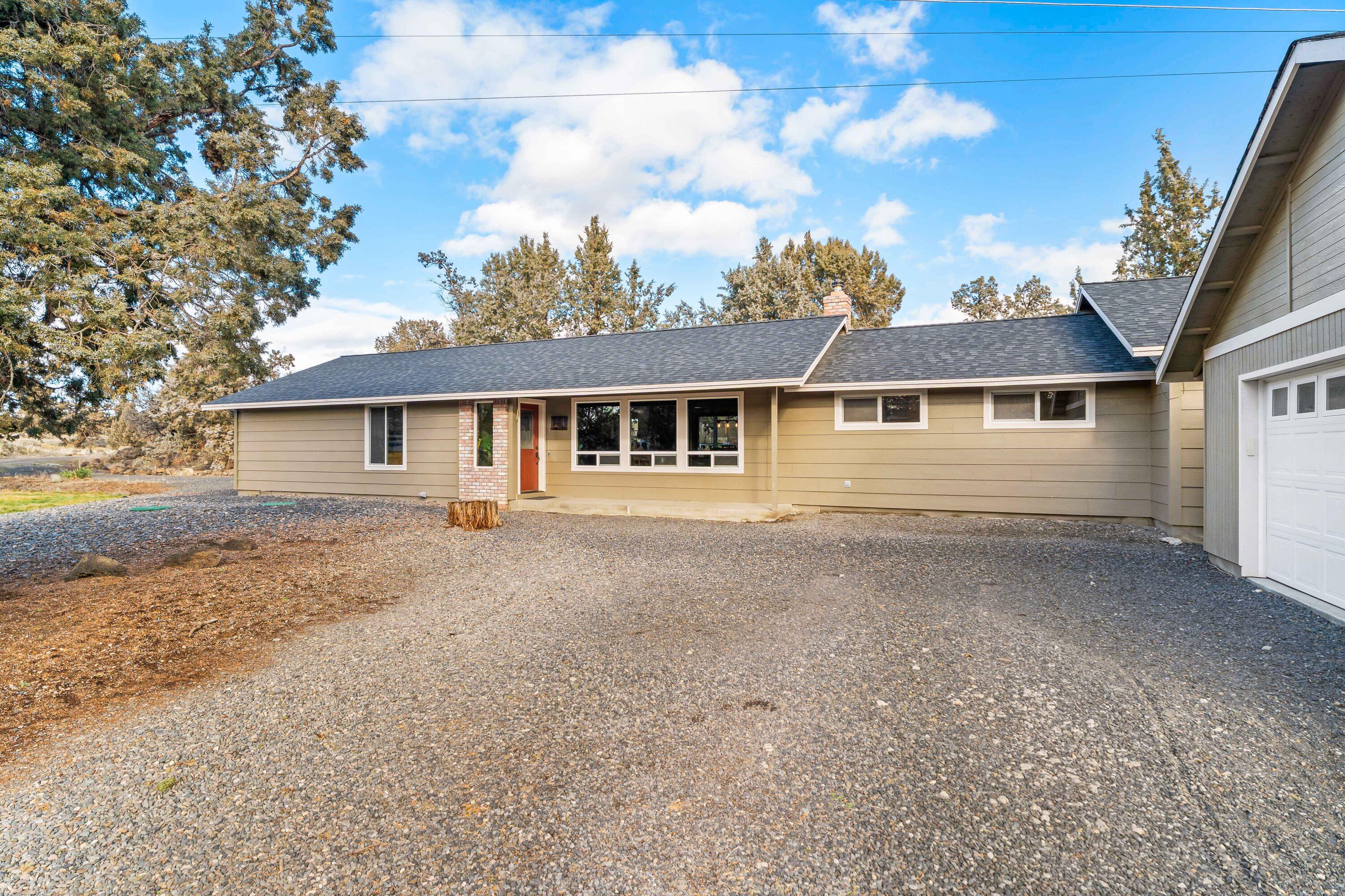 Unbeatable location between Terrebonne and Redmond! This inviting 2184 sqft, 3 bedroom, 2 bathroom home sits on over 4 acres which truly capture the essence of the Central Oregon lifestyle offering space, privacy, and everyday comfort. Enter into a bright great room featuring a cozy fireplace and sitting area, beautiful kitchen with granite tile counters, custom cabinets and slate flooring which extends through the dining area. Off the great room is a spacious living room, perfect for movie nights or gatherings. A generous bonus room with private access provides remarkable flexibility, ideal for a private home office, guest retreat, or multi-generational living. Outside you'll find tasteful landscaping, a covered concrete patio, and room to roam! Property has lots of character from rock outcroppings and old-growth juniper! Additional buildings include detached garage, greenhouse, and animal stalls + fencing.