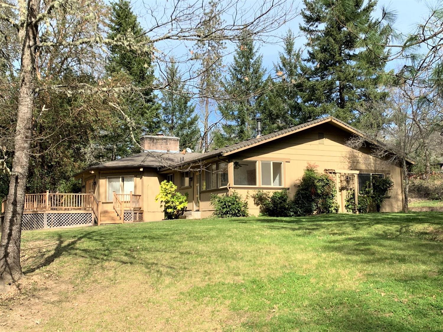 Dream setting for this beautifully re-done country stunner overlooking the creek, the neighboring ranch, and the mountains beyond. Unique floor plan and ceiling lines give you that lodge feel with the convenience of a solid floorplan. Rich knotty alder solid doors and trim throughout, and newer windows. Roomy Kitchen with tons of kitchen cabinets, tile floor, corian style counters, and soothing lighting. Gorgeous circular great room with natural wood beams radiating out from an impressive stone fireplace, plus separate family room, office, and enormous master suite featuring master bath with jetted tub, separate shower, custom cabinets with twin sinks, and private loo. The two door walk in closet is huge! Gorgeous setting, easy distance to town, and the country feel we love in southern Oregon can be yours!