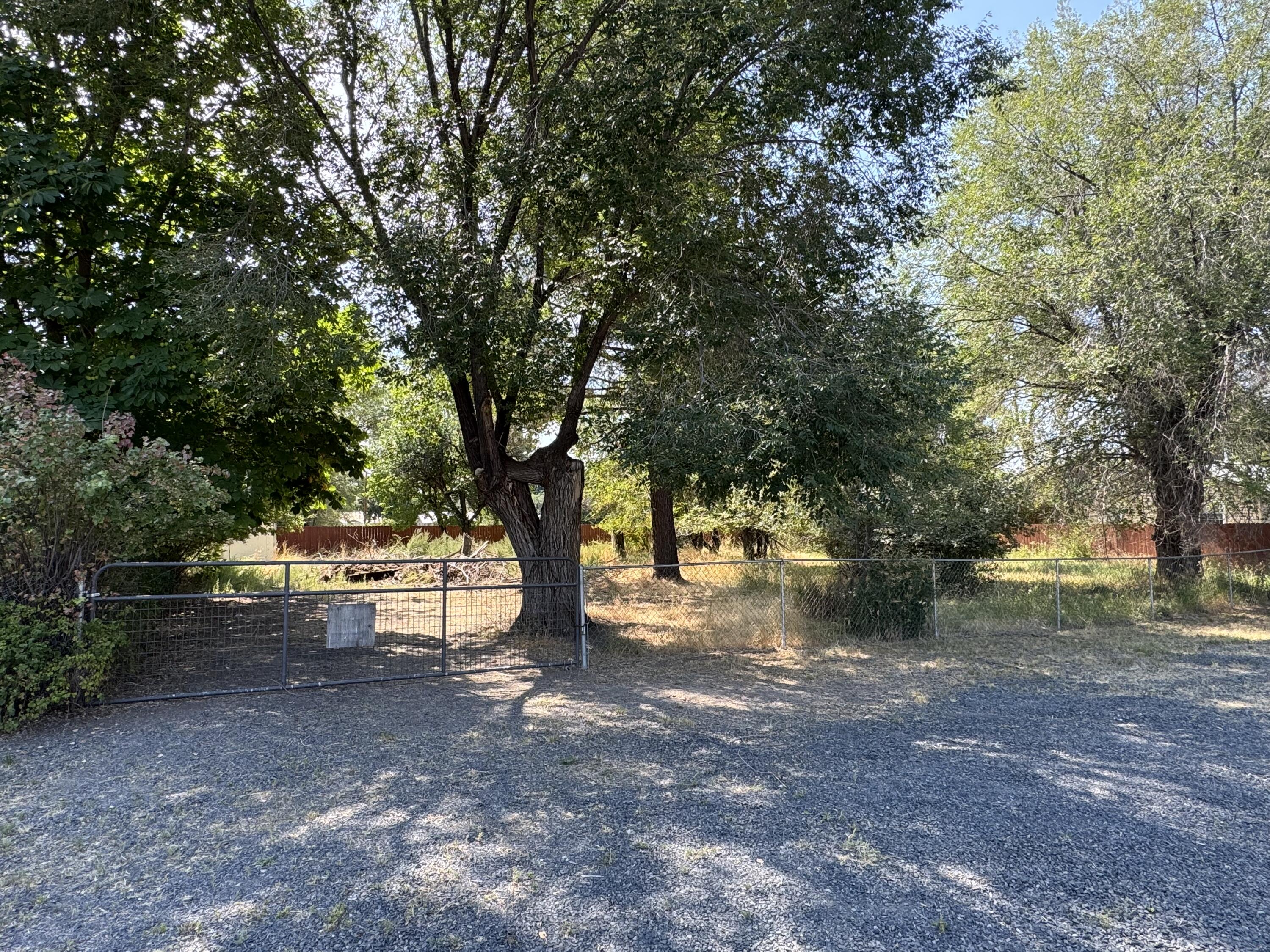 Rare opportunity! This fully fenced 1/4-acre residential lot offers mature trees for shade and privacy, a gated entrance, and a handy shed for storage. With plenty of room to design and build your dream home, the property provides both space and flexibility. Whether you're looking to start fresh with new construction or add to your investment portfolio, this lot is ready for your vision. The seller is also offering the neighboring home for sale, creating the unique chance to purchase both properties as a package. Don't miss the potential this lot provides!