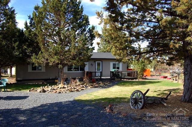 Rural acreage ready for your horses. 1.83 acres with new 36x36 barn, 3 stalls, tack room with storage above and hay storage for 5 ton hay. Property also offers loafing shed with 3 bays, shop, storage shed and dog run. Country barnwood accents throughout this 2000 Fuqua home. 3bd, 2ba, 1296sf, newer windows, doors, vinyl and laminate floors and heat pump with ac. Fenced and cross fenced with circular gated entry.