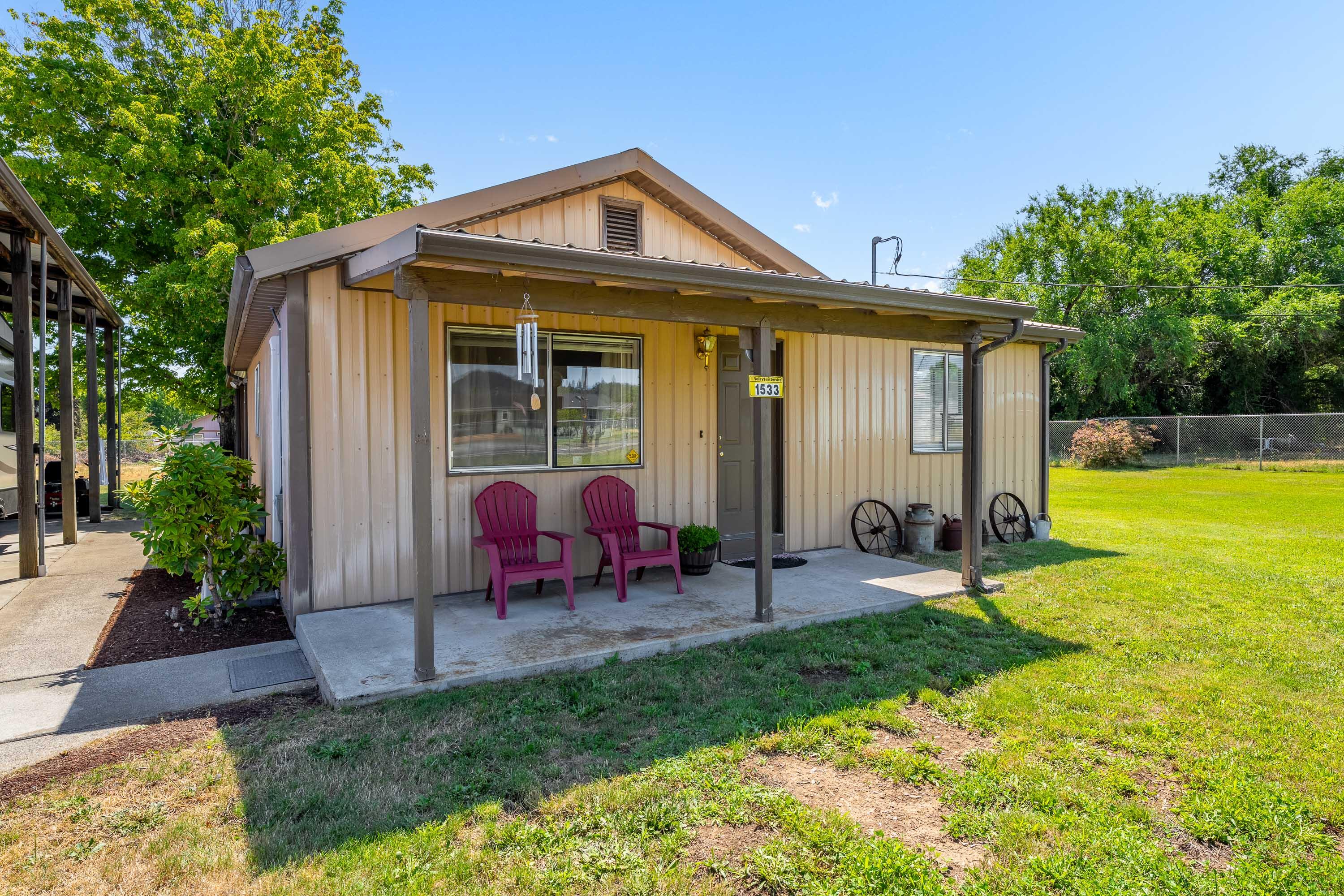 Charming 2-bedroom, 1-bath home on just over an irrigated acre with a 1500 SF shop!!  Fully fenced, gated, and conveniently close to town. Enjoy the peace of country living with modern updates including new flooring, new appliances, and a brand-new ductless HVAC system for year-round comfort. Relax on the covered front or back porch and take in the spacious, usable land. The 1,500 sq ft shop is a standout feature, complete with front and back roll-up doors, an attached carport, and endless potential for projects, storage, or hobbies.  There is also room for guests in the 360 sf detached guest room complete with full bath.  This property has so much potential - don't let it get away!