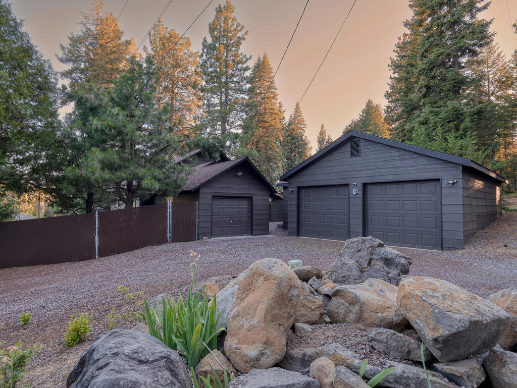 Near the Rocky Point Resort and several trophy lakes, set in the trees, come see this custom built Cedar Lindal home. This super maintained home features 2 bedrooms and 2 bathrooms with a Den, that could easily be used as a 3rd bedroom. The primary bedroom is in the loft with a full bath, spa tub and sitting area overlooking the living space.  Room enough for a king size bed  too! The exterior of the home was painted recently and sellers just installed a new ATT septic system last month. 3 types of heating, A/C & vinyl windows. All appliances stay along with the Washer and Dryer. New privacy fencing has been installed along the front of the property. Relax on the wrap around deck with check out the views. There is an attached 1 car garage along with a 30'x36' shop. The shop has a full bathroom plus a separate work space. This location and property is perfect for Full or part-time living and/or an Airbnb. Plus there is a 7'x14' swim spa & an 8'x10' Tuff shed included in the sale