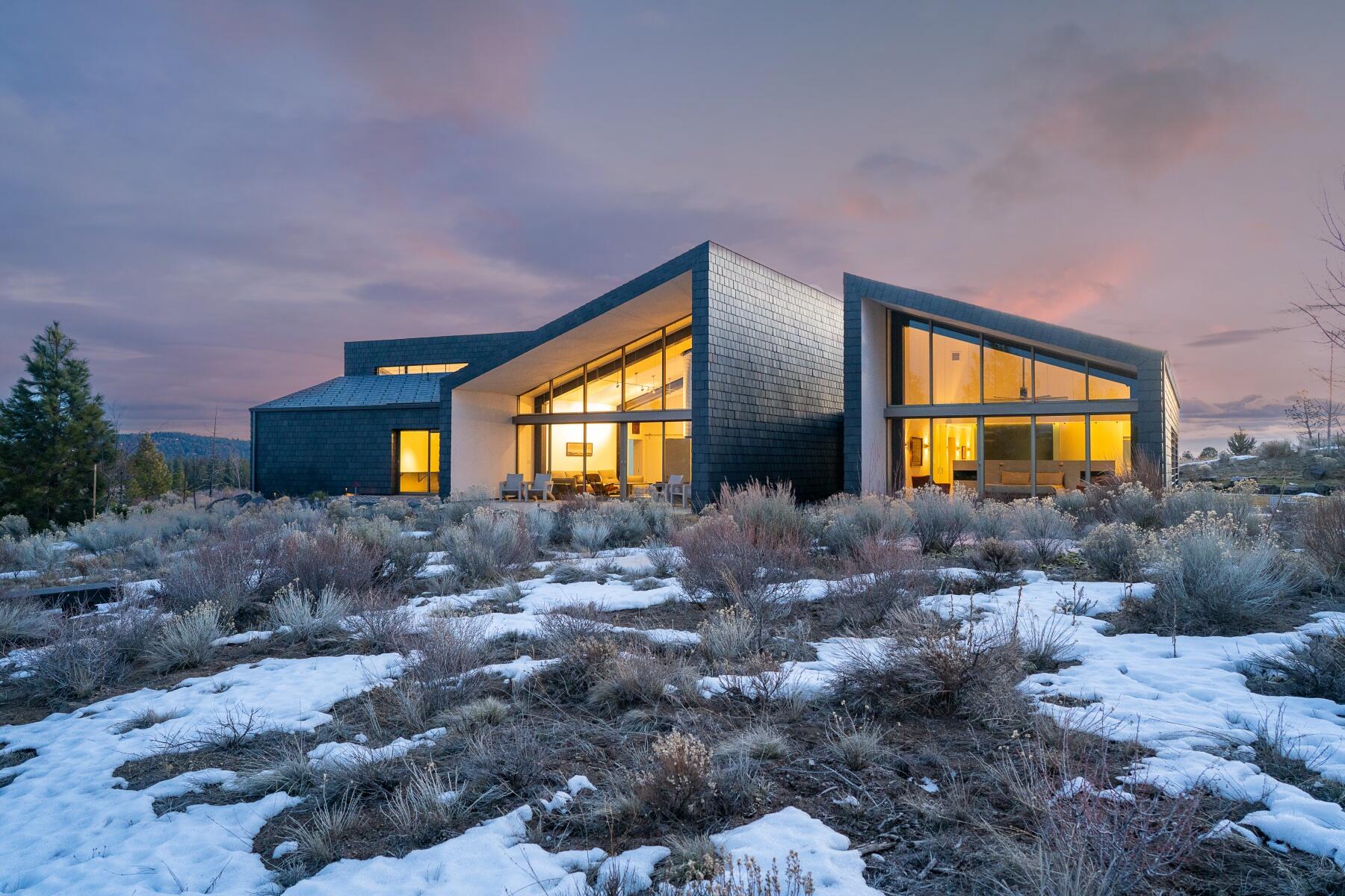Within the privacy and solitude of one of Bend's most exclusive neighborhoods sits this 4175 sq ft architectural masterpiece of unparalleled quality. Designed to take in the inescapable beauty that surrounds, this home's nature-connected spaces create a seamless transition from indoors to outdoors. Minimal, sleek designs complement the soaring twenty-two foot sloped ceilings. Expansive walls of windows open to the mountain landscape, creating powerful synergy between modern living and nature. Built with a focus on sustainability and efficiency, this home's innovative use of technology includes solar energy, geothermal and radiant heat, and mini splits to maintain comfort, while ICF walls and structural insulated panels ensure optimal insulation all year round. The home's distinct and numerous outdoor spaces allow for an undisturbed experience with nature, and when adventure calls, Phil's trail, the Deschutes river, local markets, dining and the best of Bend is at your doorstep.
