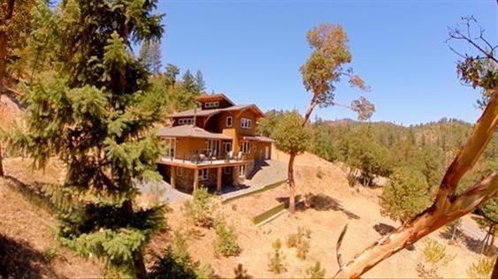 Breathtaking views surround this beautiful home on 140 acres bordered by BLM. Super strong and energy efficient ICF construction. Possible office or extra bedroom without a closet. Maximum heat efficient Tulikivi Soapstone fireplace, wine cellar, rain catchment system and hot tub are some of the special features of this home. Kitchen has granite counter tops with a gorgeous, curved, wood bar and stainless steel appliances. Retreat to the 3rd floor master suite and relax in the soaking tub with incredible view. Home has a backup generator and is wired for Solar. Per Seller, well flowed at 13 GPM when last tested. The wrap around deck is a perfect way to enjoy this very peaceful setting. Come see for yourself!