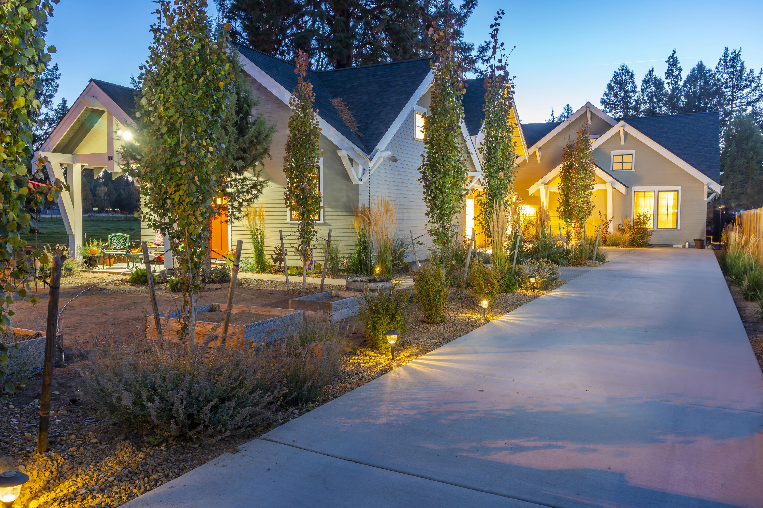 Discover a truly unique gem with 3 distinct living spaces, masterfully designed by award-winning Muddy River Design. This exceptional property is perfect for a family compound, multigenerational living, or an incredible investment with multiple income streams. Behind the gated entrance, an oasis awaits, featuring lush gardens, captivating outdoor living spaces, and striking rock outcroppings. The main house, boasting 1930 sq ft, includes a lock-off suite with a private entrance and kitchenette. A 2-car garage with a stylish 364 sq ft studio above, complete with a full bath, adds to the allure. The charming front cottage (ADU) offers 576 sq ft of comfort with 1 bed and 1 bath. Nestled on a spacious .33-acre lot, this property is a haven for gardening, recreation, and outdoor entertaining. Topping it all off, this home is Earth Advantage Platinum certified with a perfect 10/10 energy score. Experience unparalleled living at 61435 Brosterhous Rd - a property like no other
