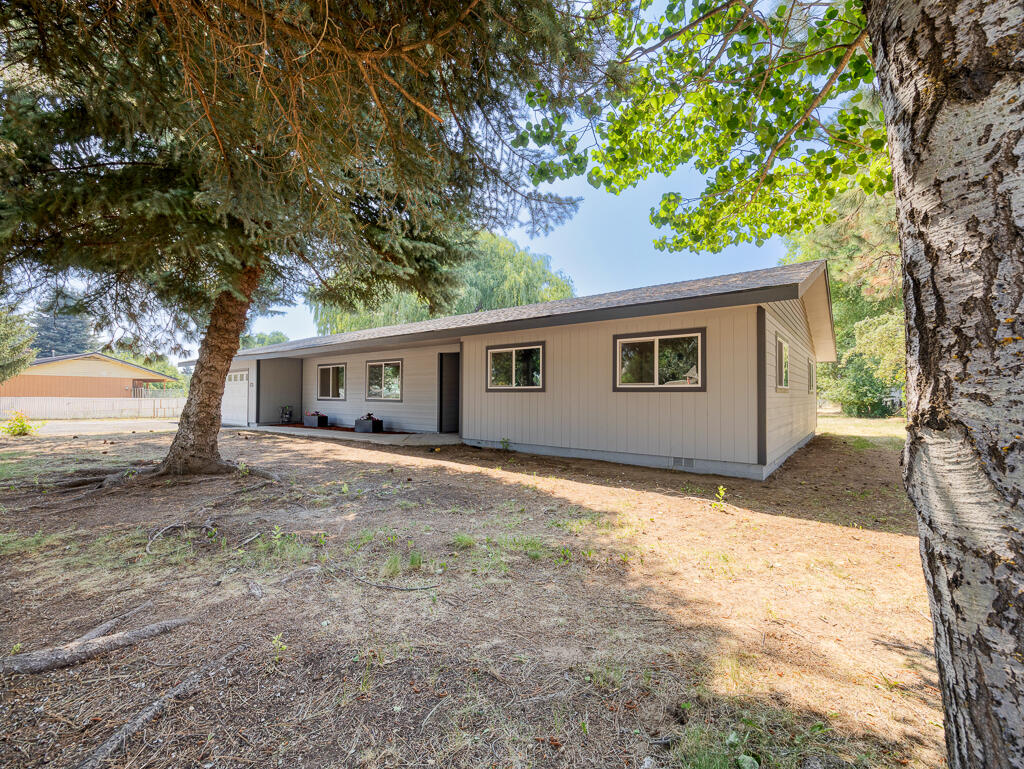 Welcome to this newly remodeled 3-bed, 2-bath, 2,066 sqft home with a bonus room for a 4th bedroom or spacious office. As you arrive, you'll notice fresh exterior paint, brand new energy-efficient windows and doors, and a new entry sidewalk. A brand-new roof and HVAC system (including all-new ducts) ensure year-round comfort. Step inside and be wowed by the all-new interior finishes. The heart of this home is the spacious, fully redesigned kitchen featuring brand-new cabinetry, gleaming countertops, stainless steel appliances, and a massive walk-in. Both bathrooms have been completely renovated with modern fixtures and beautiful finishes, while the entire home shines with fresh interior paint, new Tuffcore Estate Collection laminate flooring, and updated ceiling lighting throughout. A large laundry room adds function, and a new water heater ensures efficient living. Outside, enjoy the bounty of established fruit trees- apple, plum, and cherry alongside a large shed all upon a full acr