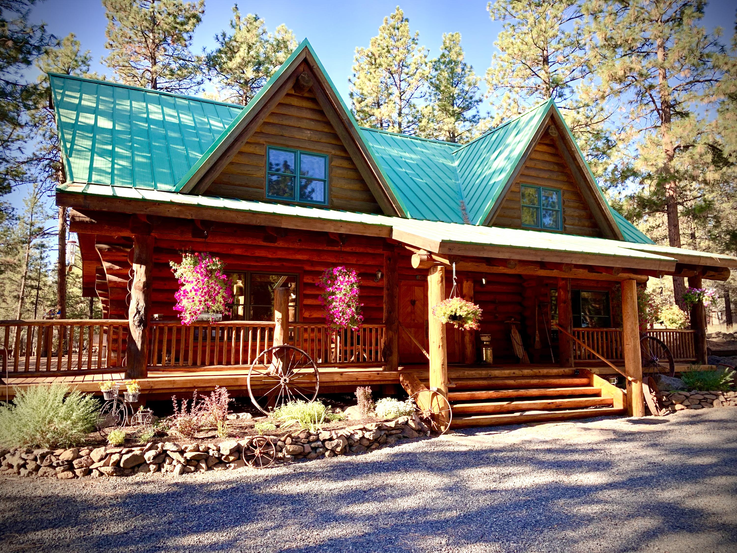 Stunning hand scribed Oregon Log Home with no detail missed. Perfect for a retreat getaway or primary residence. Hand-crafted 2-story stone F/P is the heart of the home w/windows galore to bring in an abundance of light & natures beauty from this almost 4-acre parcel in the trees. Amazing custom staircase w/2 Skip Armstrong carvings & stunning Junipine base. Spacious kitchen w/butcher block island. 2 guest bedrooms downstairs & an upstairs primary suite w/separate reading area & TV room! Once you walk in you won't want to leave! Truly a Log home masterpiece, so warm & inviting! Property also offers a large 2-car shop w/full permitted bathroom, additional storage & side shelter overhang for equipment & toys. Beautiful flower garden, outdoor fire pit & wood storage shed finish off this amazing property. Junipine Acres offers homeowners private access to the gated neighborhood park & picnic area, which winds along Whychus Creek. Call for your showing today!