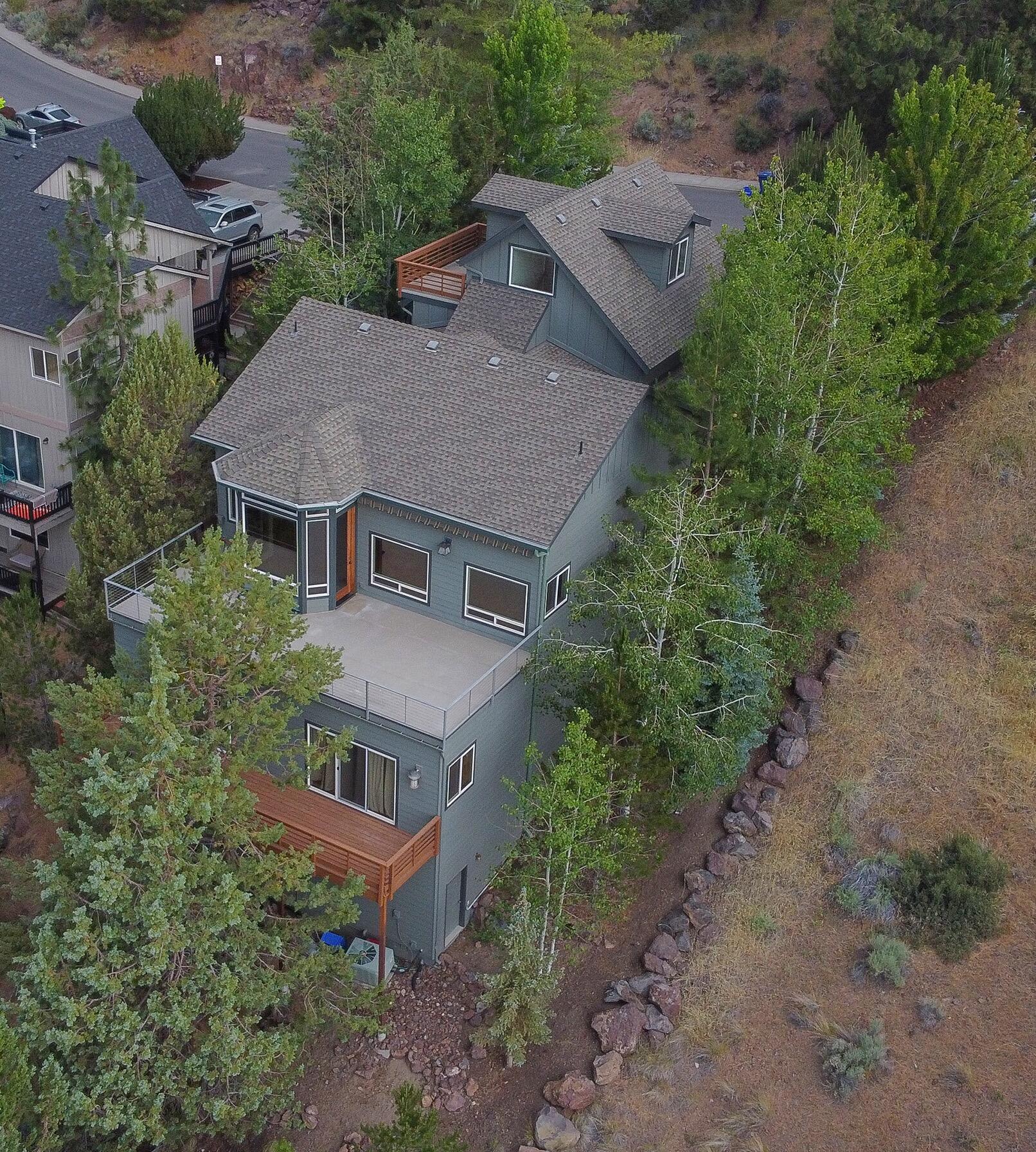 Premier Westside location!  This is not a drive by property as you can't tell how grand this home is from the street. Enjoy tree top panoramic views of Lava Butte, Old Mill and Mt. Bachelor just to name a few from this magnificent 3,320 SF home on a .20 acre lot. Offering 5 bedrooms, 3 full/2 half baths plus an office/flex space above the garage that has another deck expanding your views to the west. There are generous storage spaces below the home and inside that were thoughtfully designed. From the wood floors, quality cabinetry and finishes this home will surely delight you as there is too much to list and so much to see. Minutes from City of Bend's Overturf Butte Reservoir property which includes an off-leash dog area near Skyliner Summit Loop and can be accessed from trail connection at the park. The trail also provides access to the Cascade Highlands Trails that also connects to the forest service's Phil's Trail system.