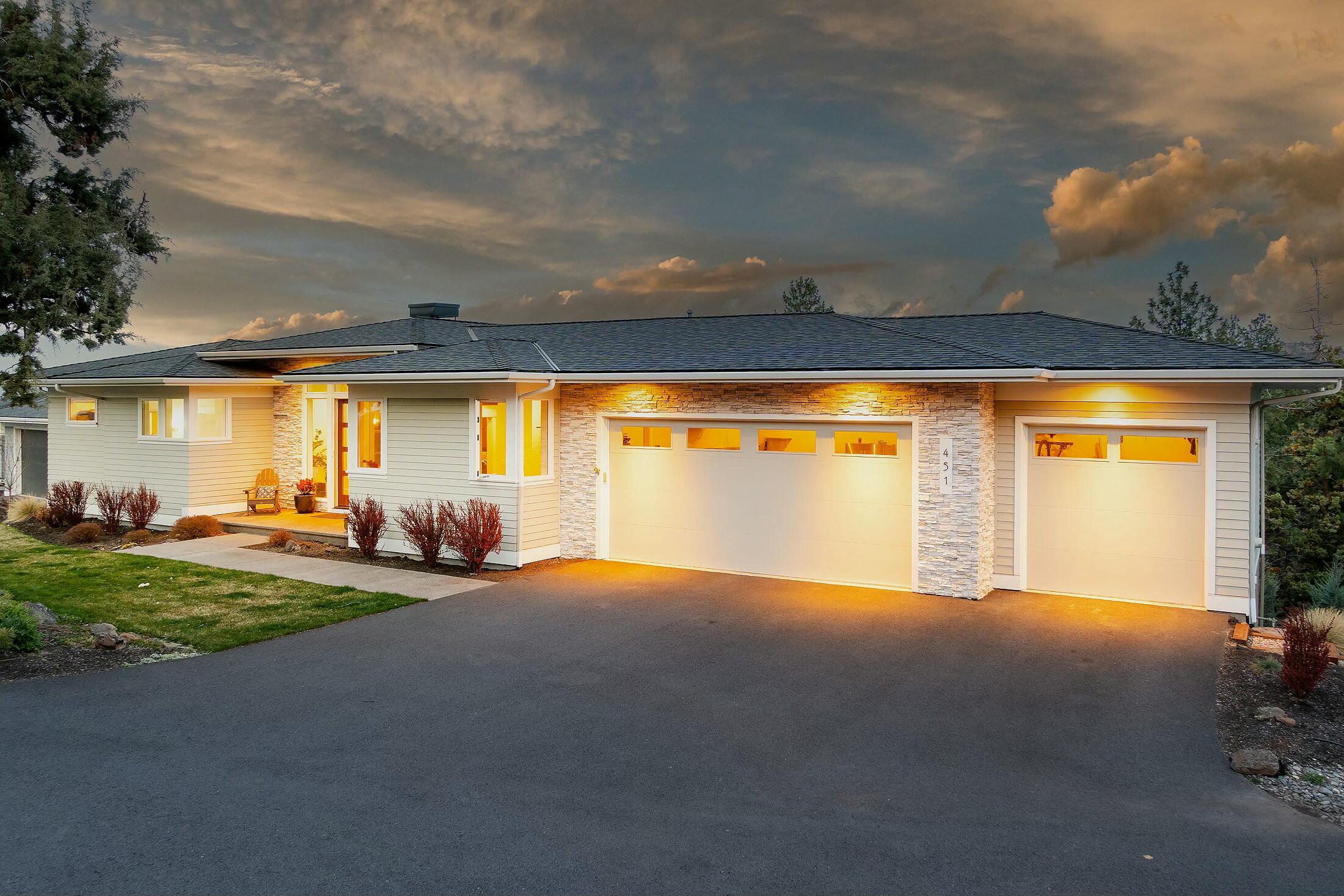 This beautifully designed home offers a perfect blend of comfort, style, and convenience. Step inside to discover a bright, open floor plan with vaulted ceilings, expansive windows, & high-end finishes throughout. The spacious gourmet kitchen boasts stainless steel appliances, custom cabinetry, & a large island—perfect for entertaining. The living area features a cozy fireplace and access to the outdoor patio, where you can enjoy breathtaking views. The primary suite is on the main floor featuring tiled shower, tub & a generous walk-in closet. Additional bedrooms downstairs provide ample space for family, guests, or a home office. Outside, the beautifully landscaped yard and covered patio create the ideal setting for year-round enjoyment. A 3-car garage and abundant storage throughout the home ensure there's plenty of room for all your gear, tools, and outdoor equipment.